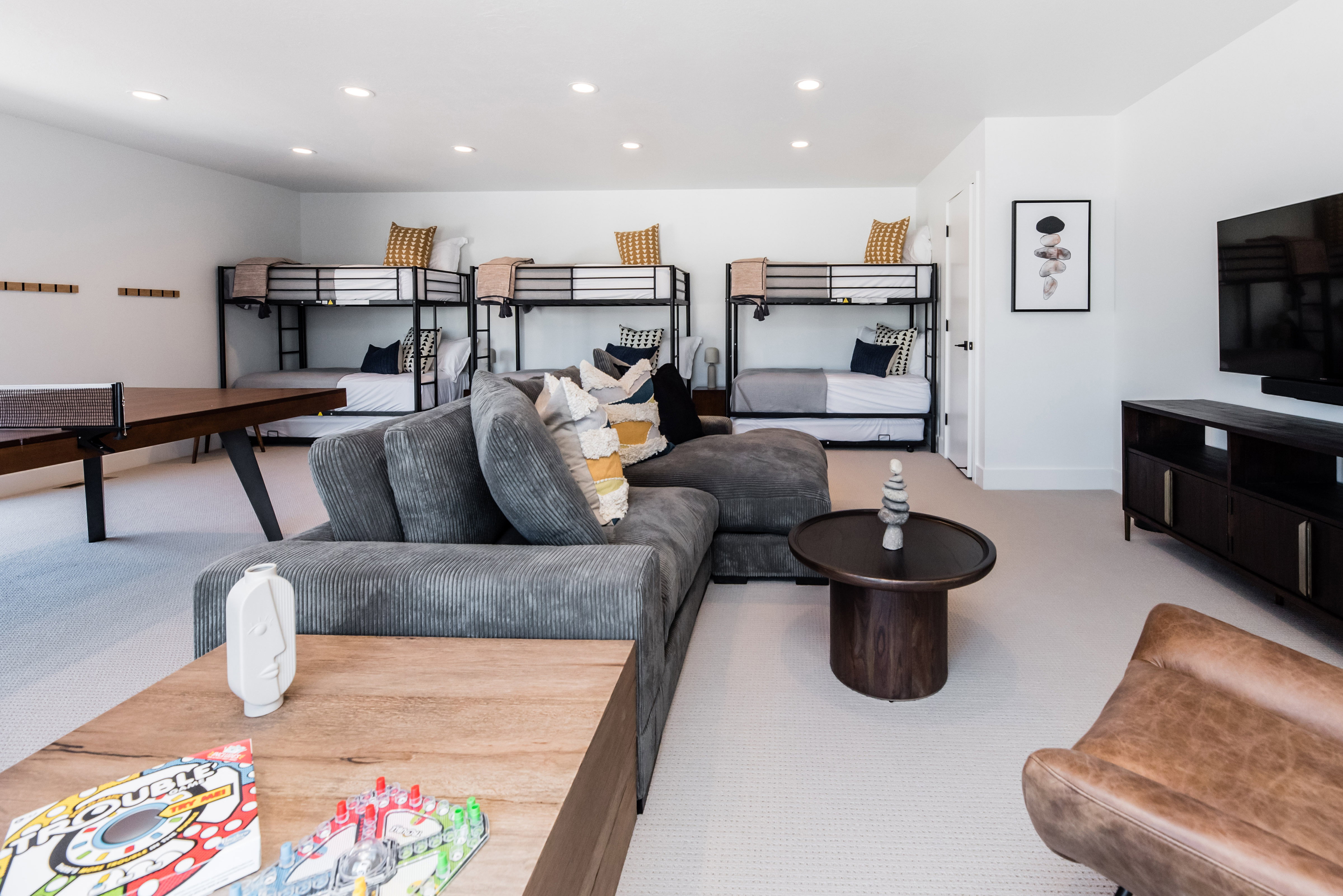 Spacious entertainment room featuring recessed lighting and light-colored carpeting