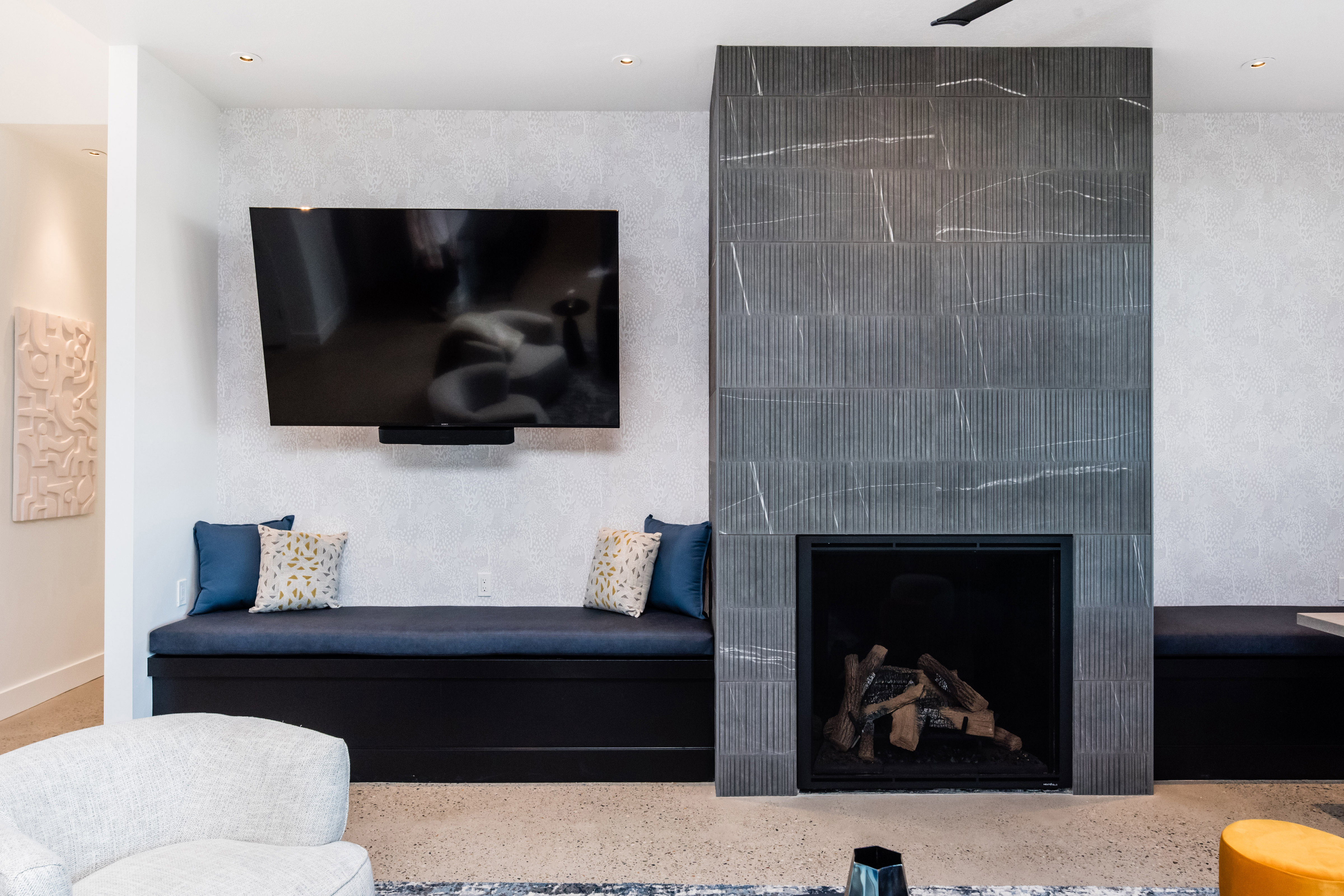 Contemporary fireplace with textured tile surround and recessed hearth