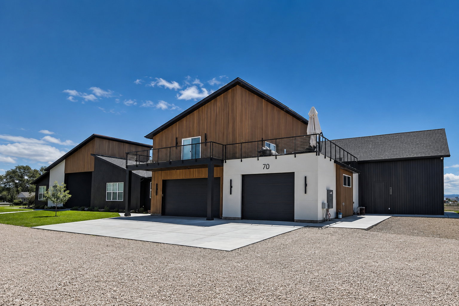 Modern barn-style architecture featuring wood-finish siding and dark vertical paneling