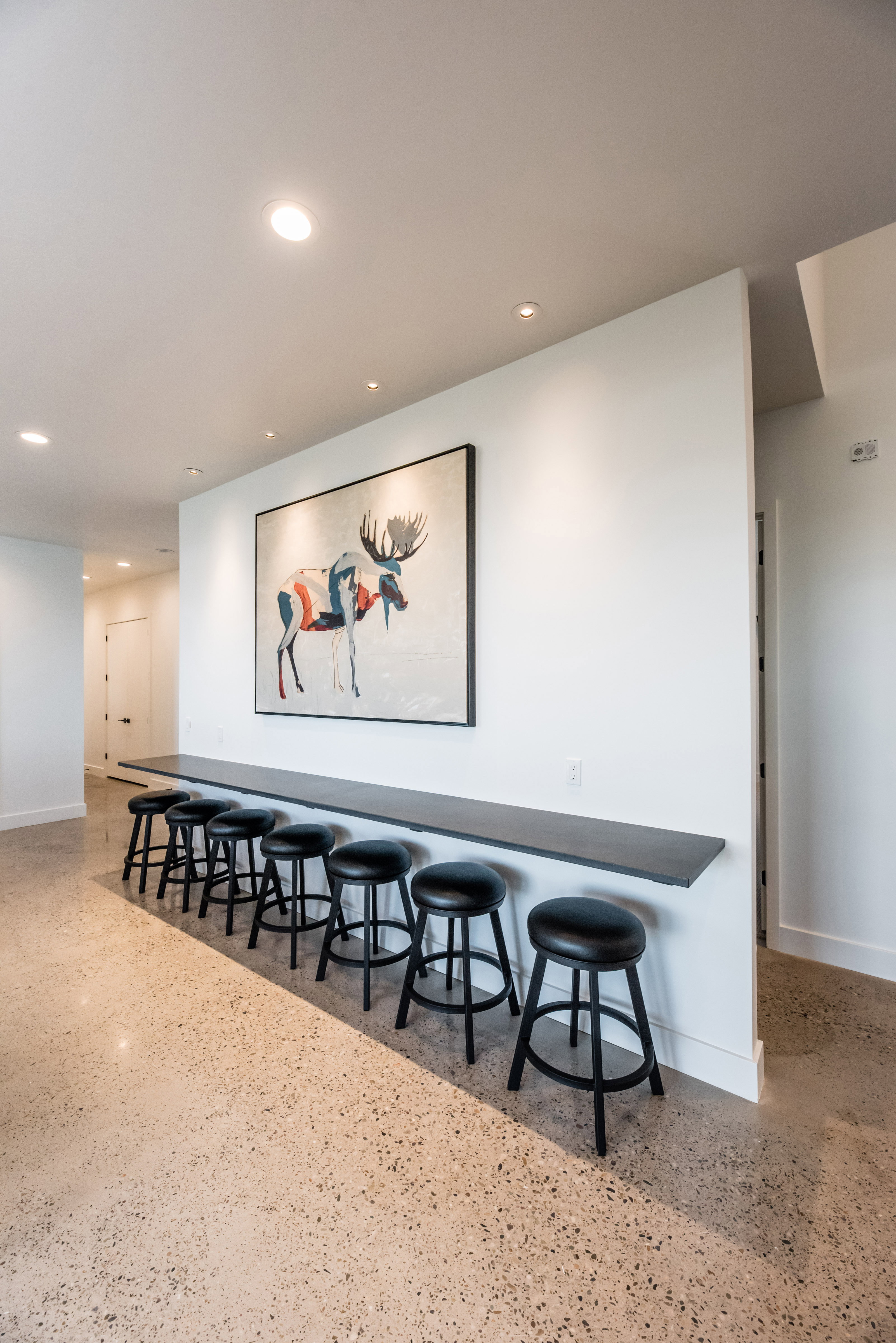 Polished concrete flooring complemented by a built-in shelf