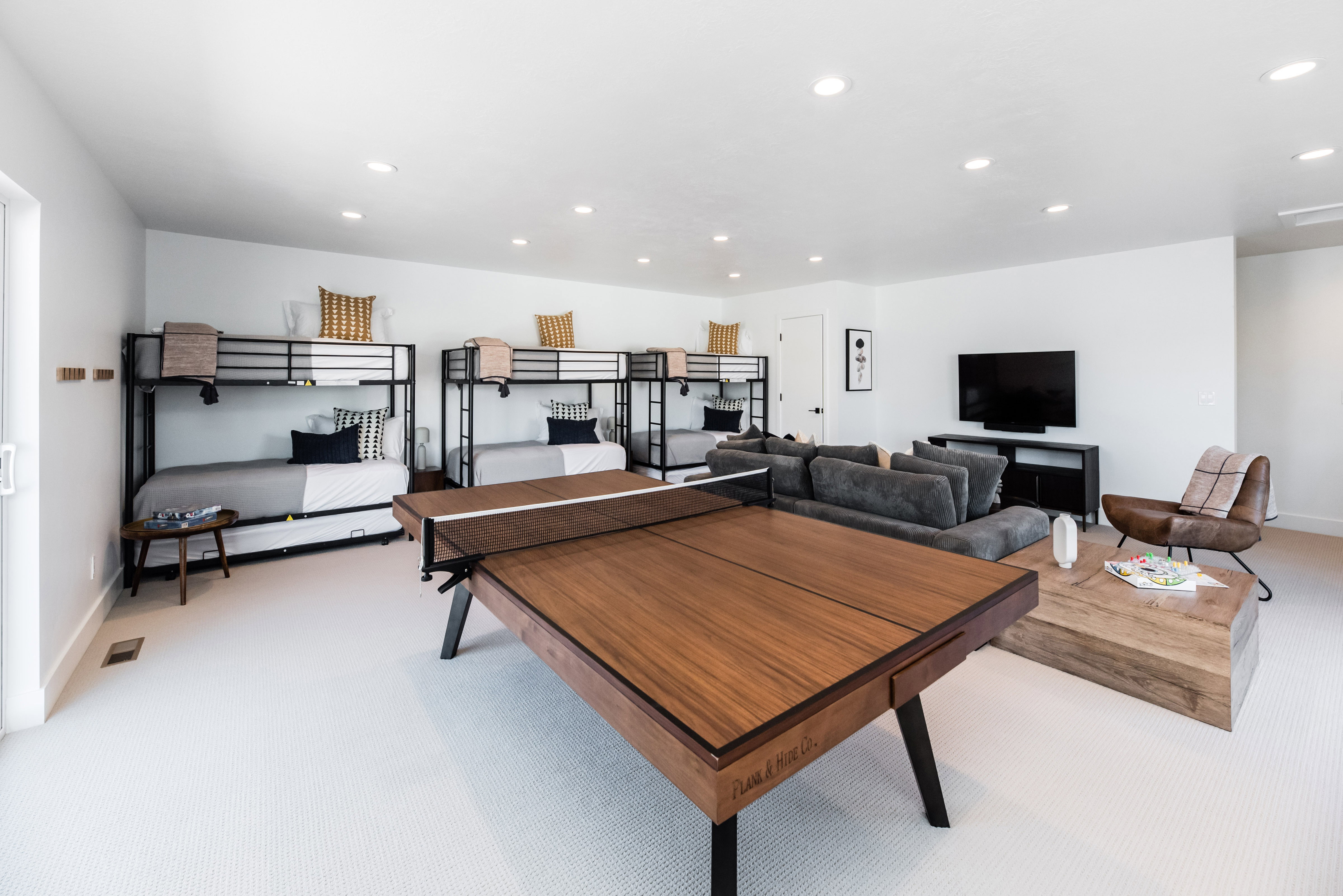 Spacious recreation area featuring recessed lighting, light-toned carpeting, and white walls