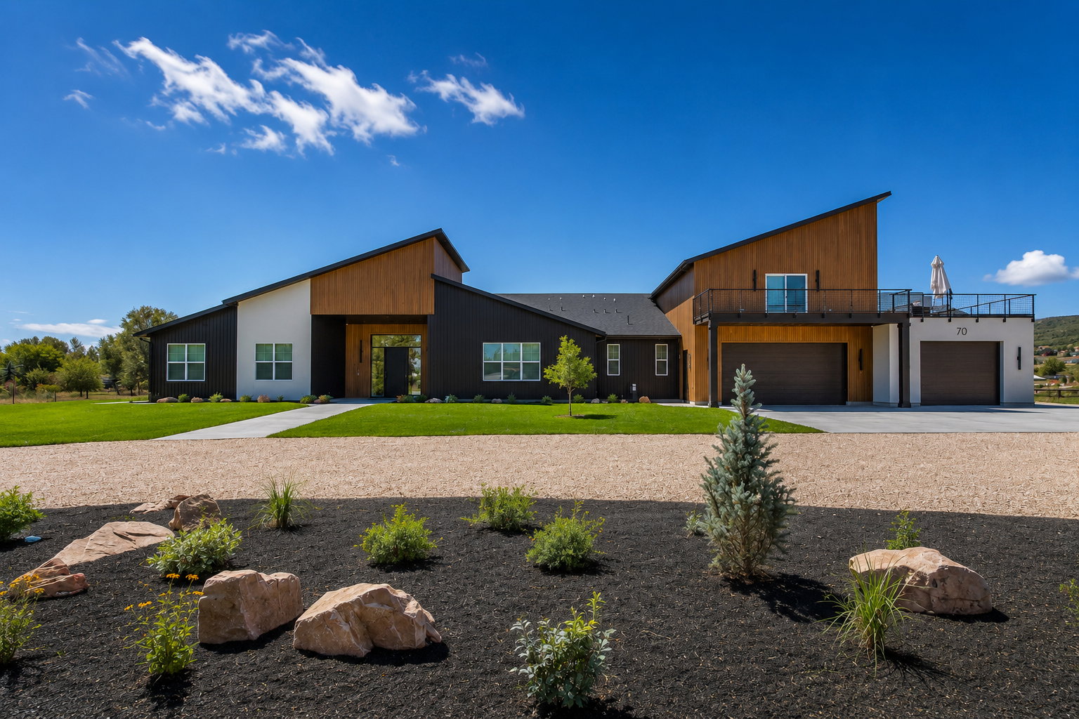 Modern architectural exterior featuring contrasting black and white siding with wood-tone accents