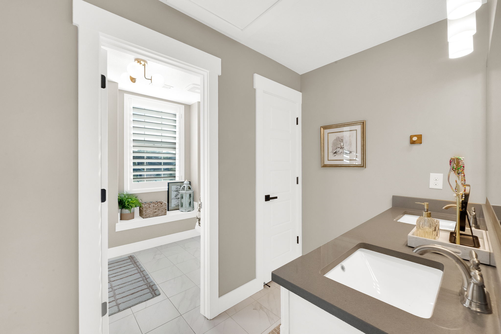 Double vanity featuring undermount sinks and dark countertops