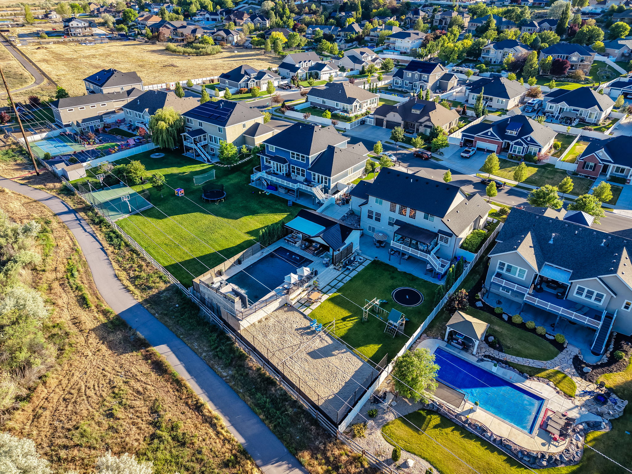 Expansive property featuring a private swimming pool, concrete patio, and an artificial turf putting green
