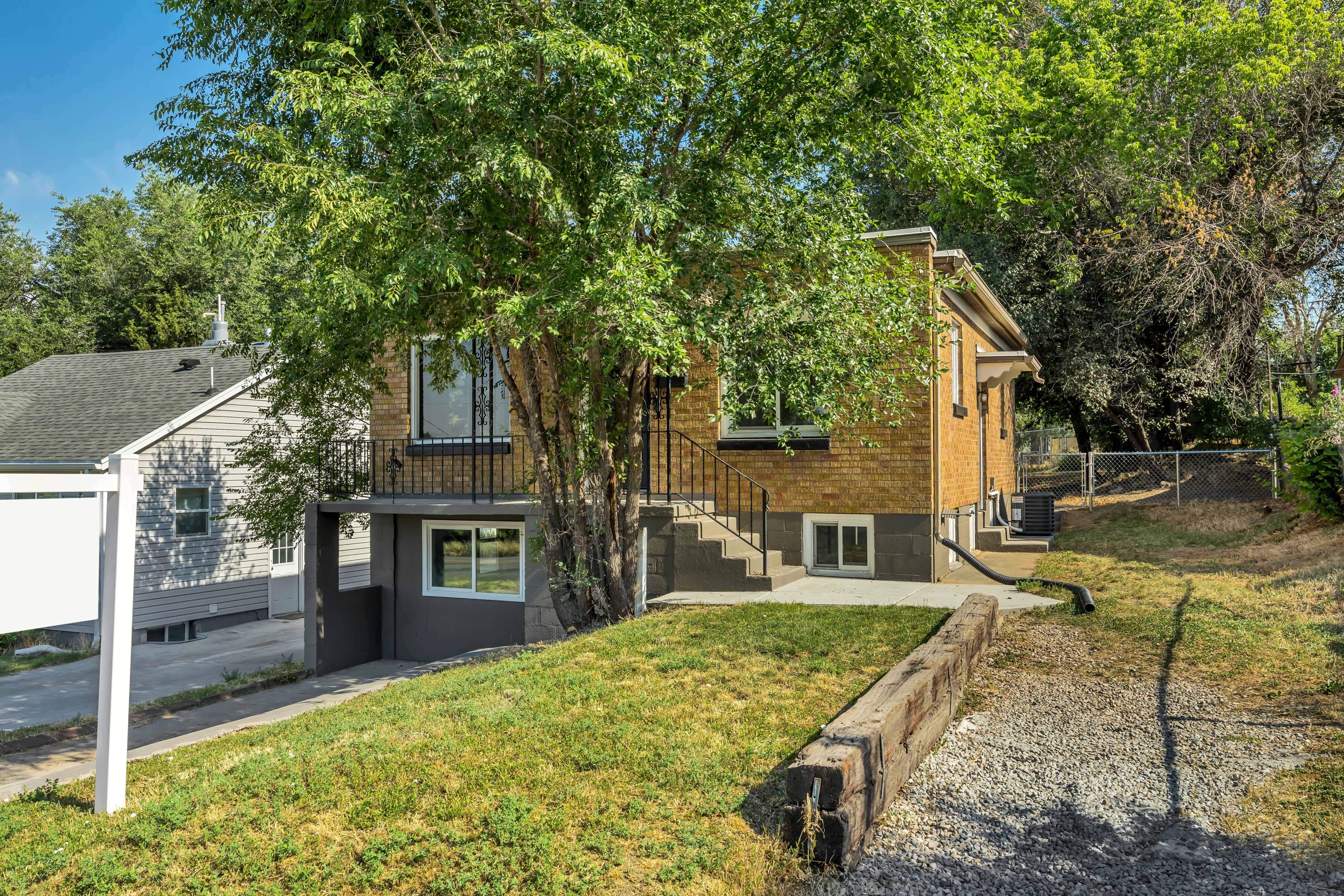 Two-story property featuring a brick exterior and a ground-level entrance with a balcony above