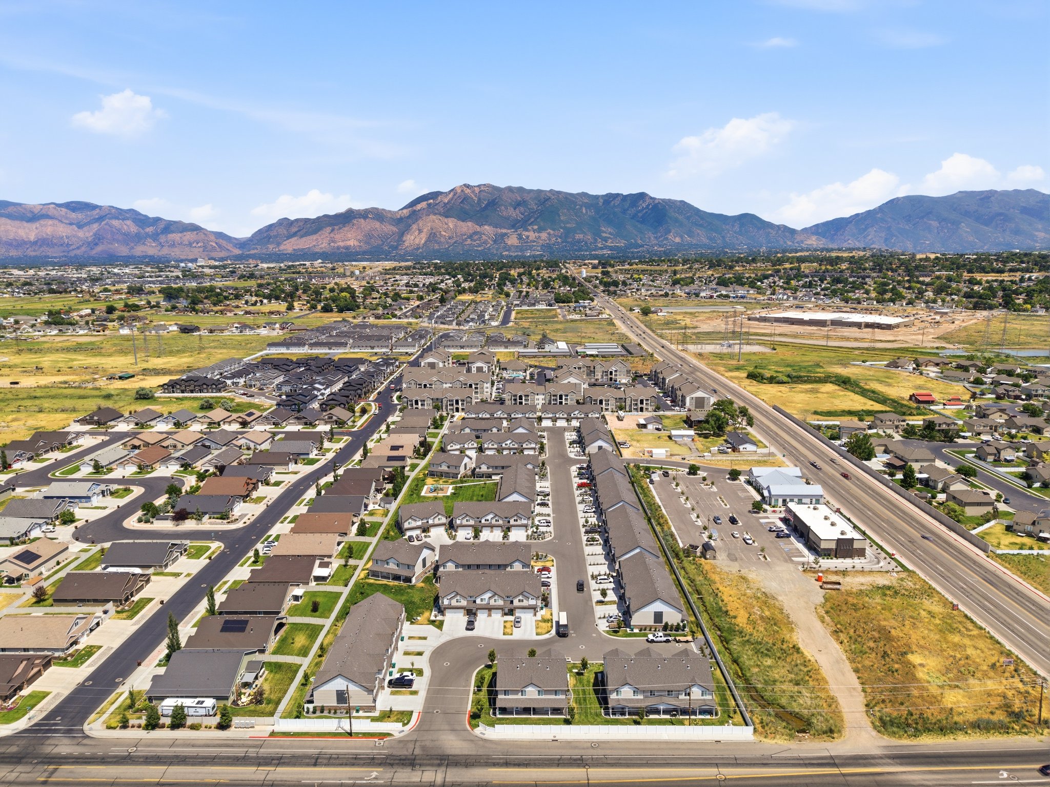 Aerial perspective showcasing a residential area with varied housing types, including single-family homes and multi-unit buildings