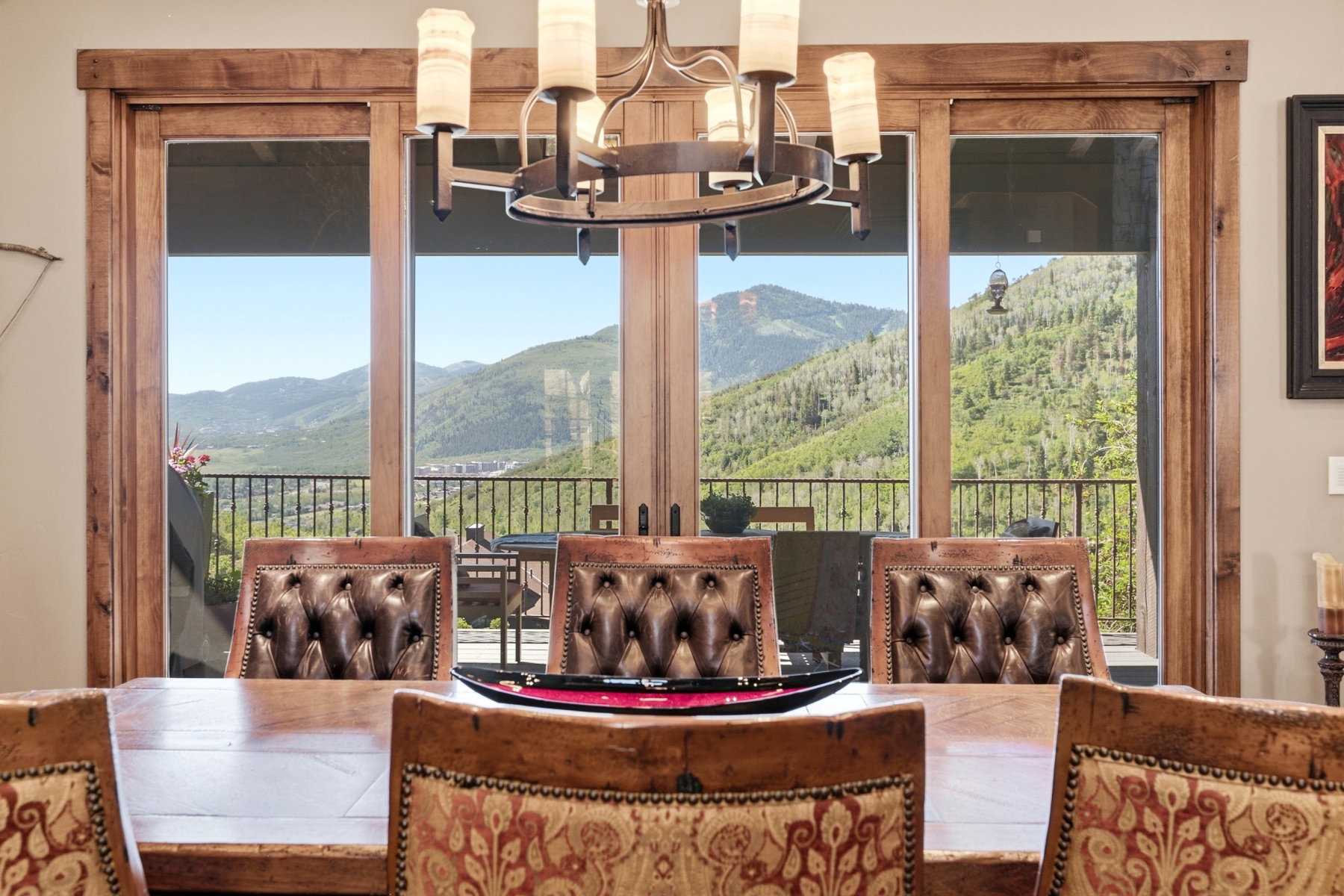 Expansive patio doors with natural wood trim offering a mountain backdrop