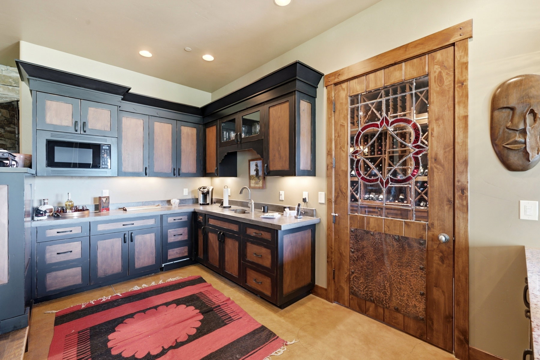Wet bar featuring two-tone cabinetry, a built-in microwave, and recessed lighting