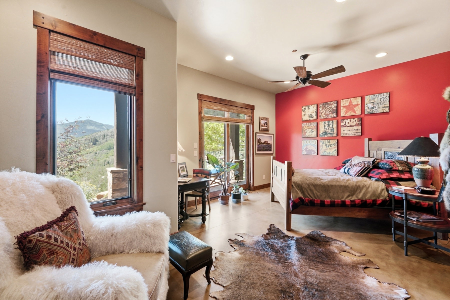 Spacious interior featuring a large picture window with natural wood trim, a sliding glass door, recessed lighting, and a ceiling fan