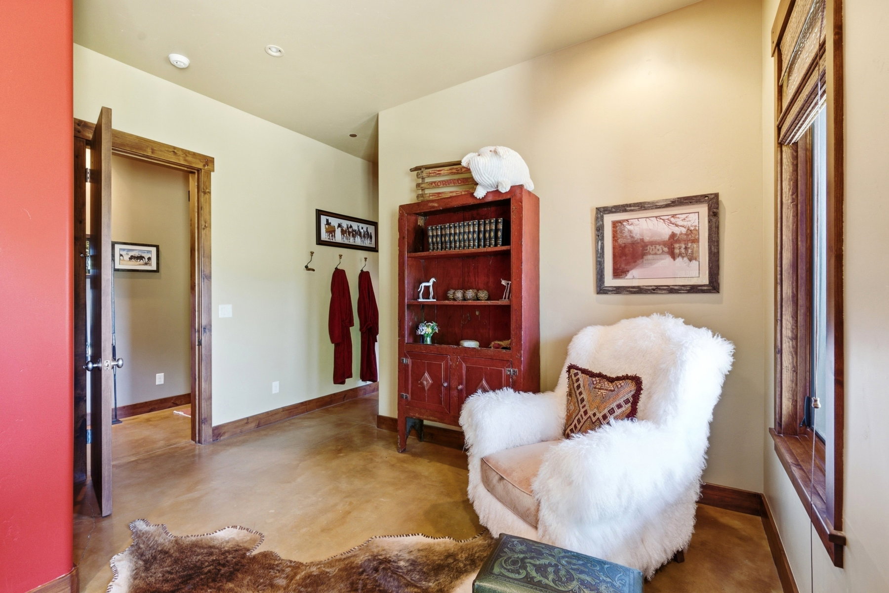 Interior space featuring a window with wood-finish trim, a recessed light fixture, and light-toned walls