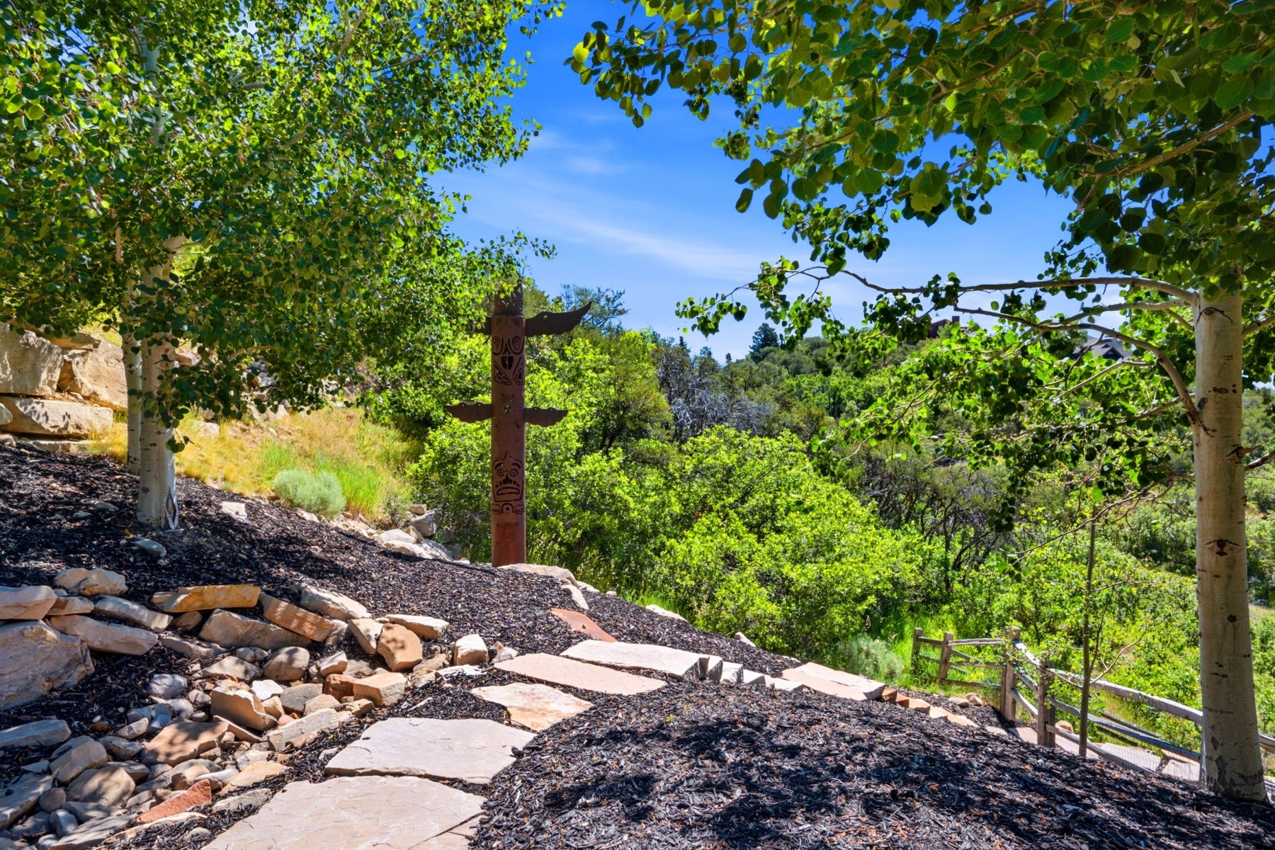 Stone pathway surrounded by dark ground cover