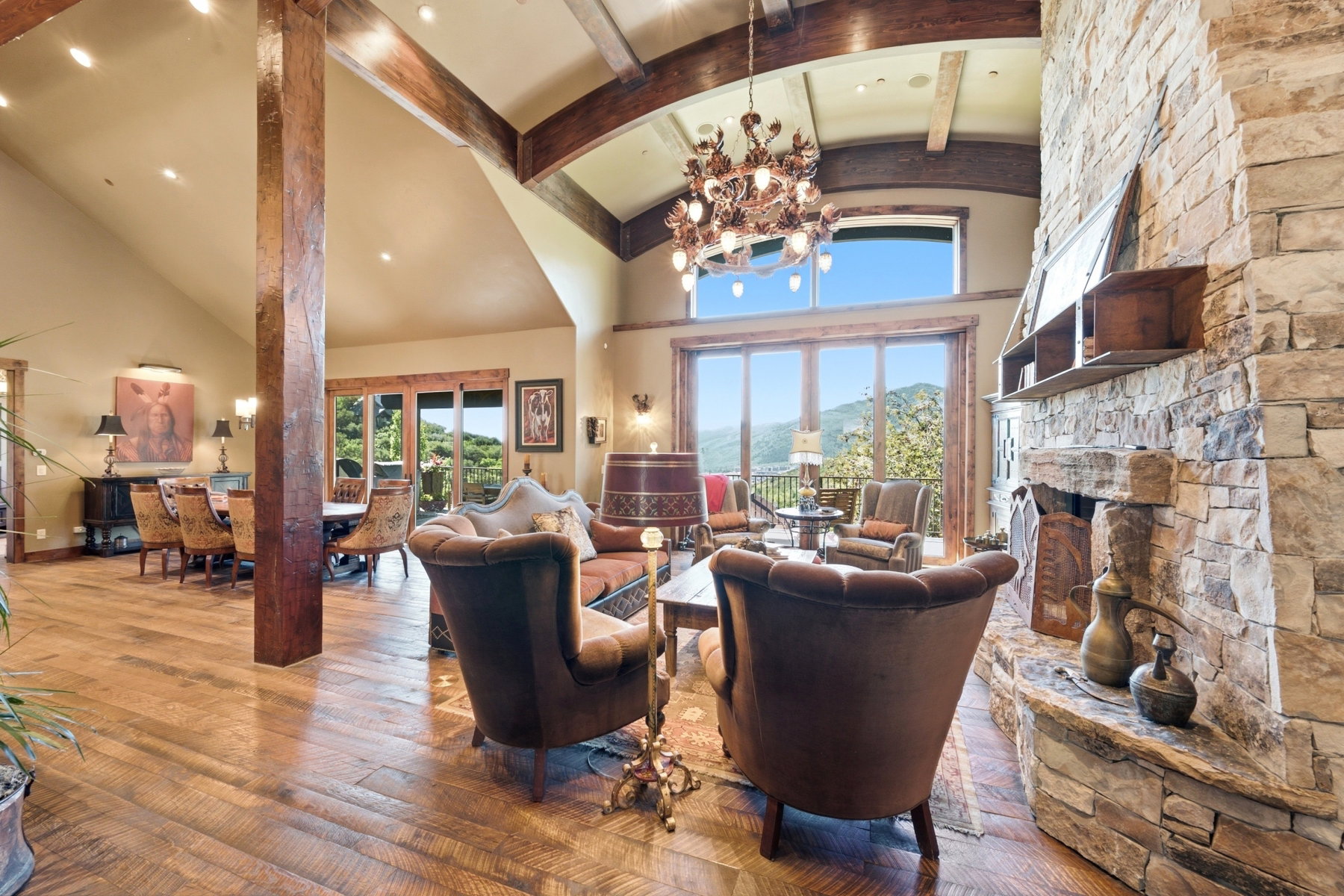 Exposed wood beams and columns complement the natural stone fireplace