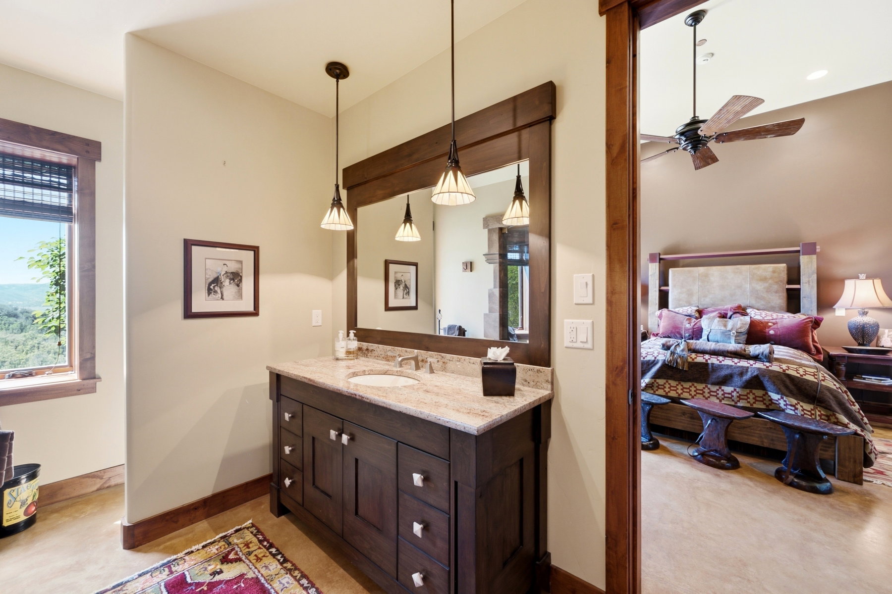 Bathroom vanity featuring a light-toned countertop, integrated sink, and dark wood cabinetry with multiple drawers