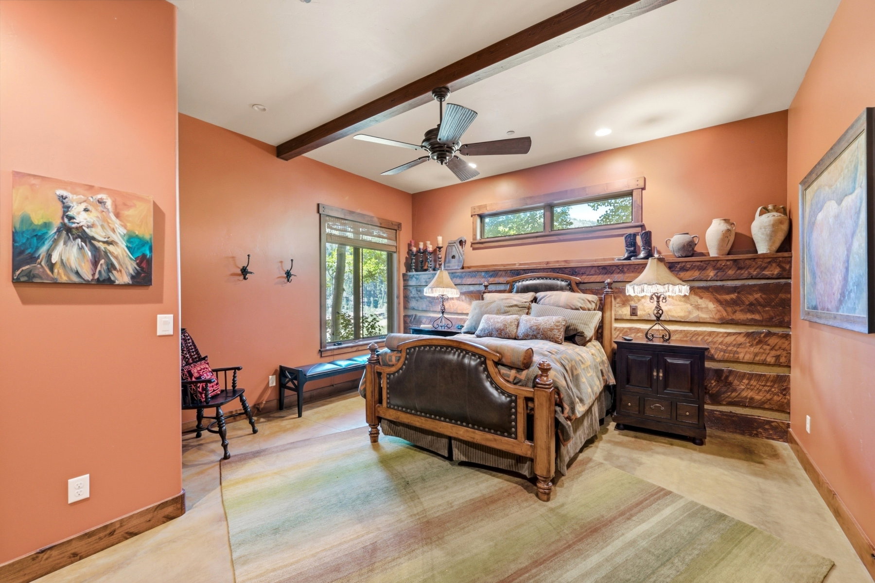 Spacious room featuring exposed wood ceiling beams, a ceiling fan, and recessed lighting