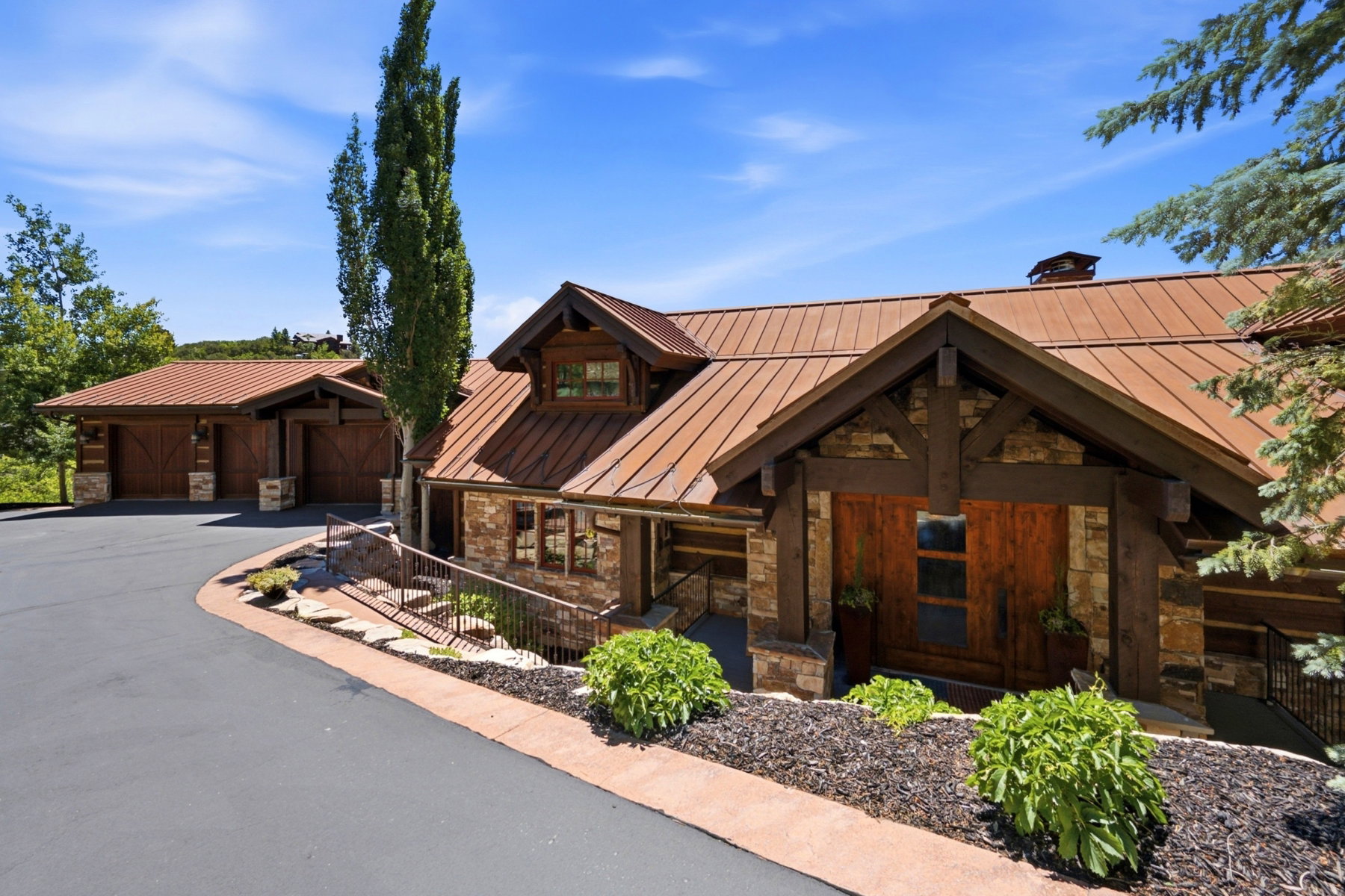Stone and timber-frame exterior featuring a metal roof
