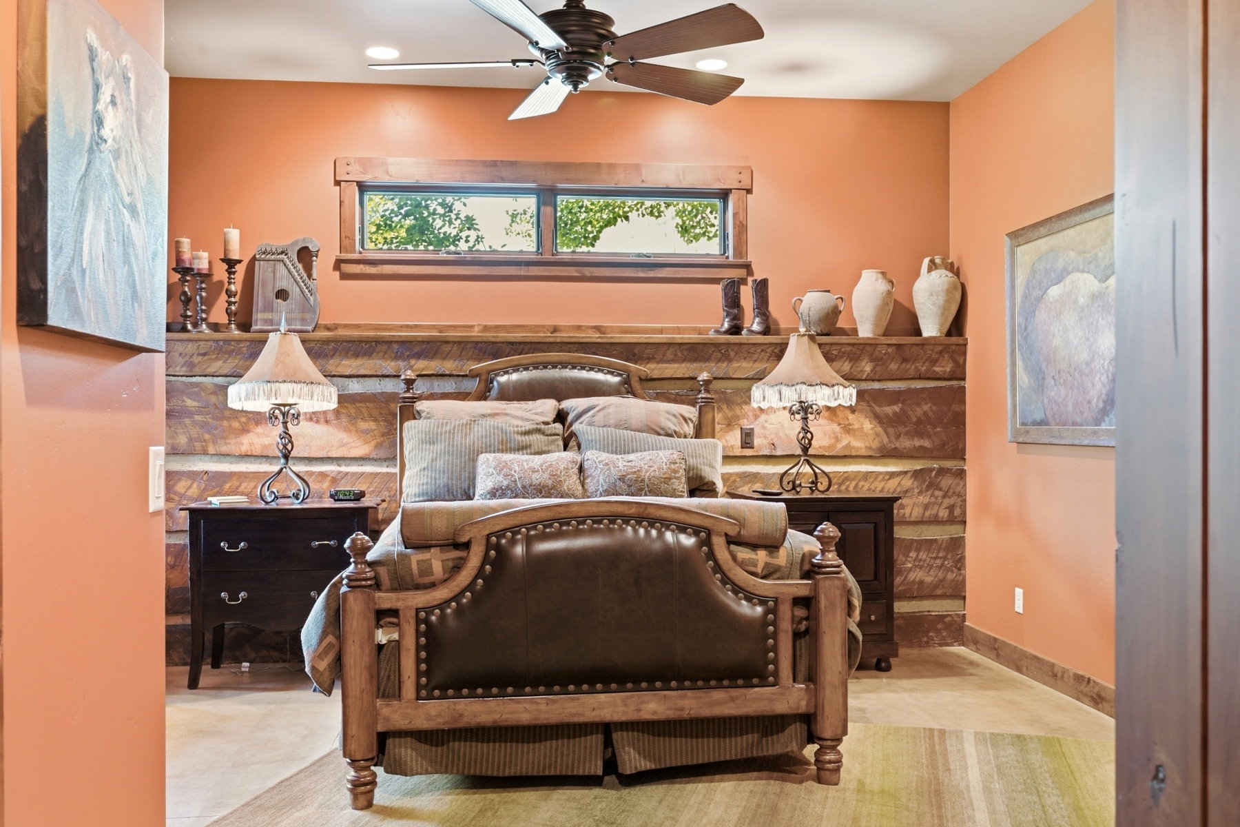 Bedroom with exposed log wall detailing and a wooden window frame