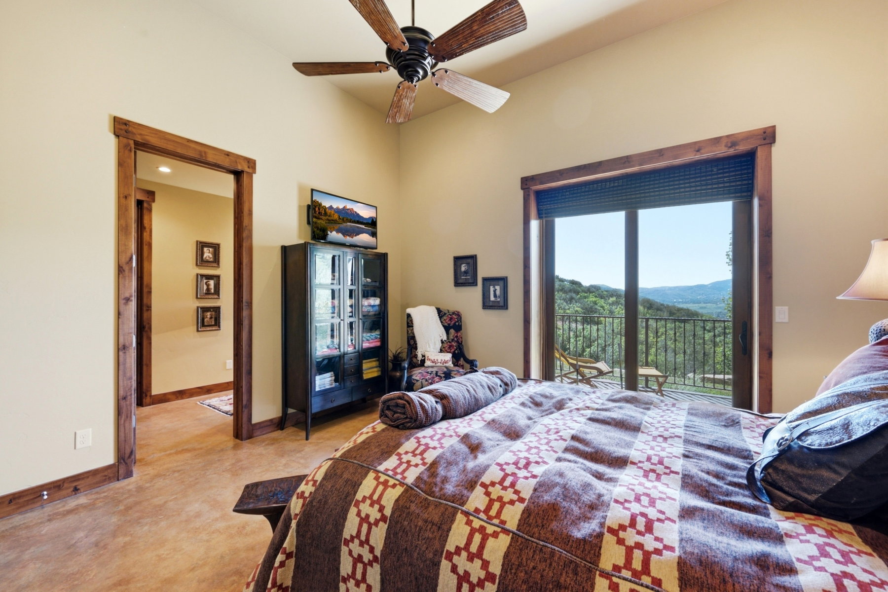 Interior room featuring wood-finish flooring, vaulted ceilings, and a wood-bladed ceiling fan