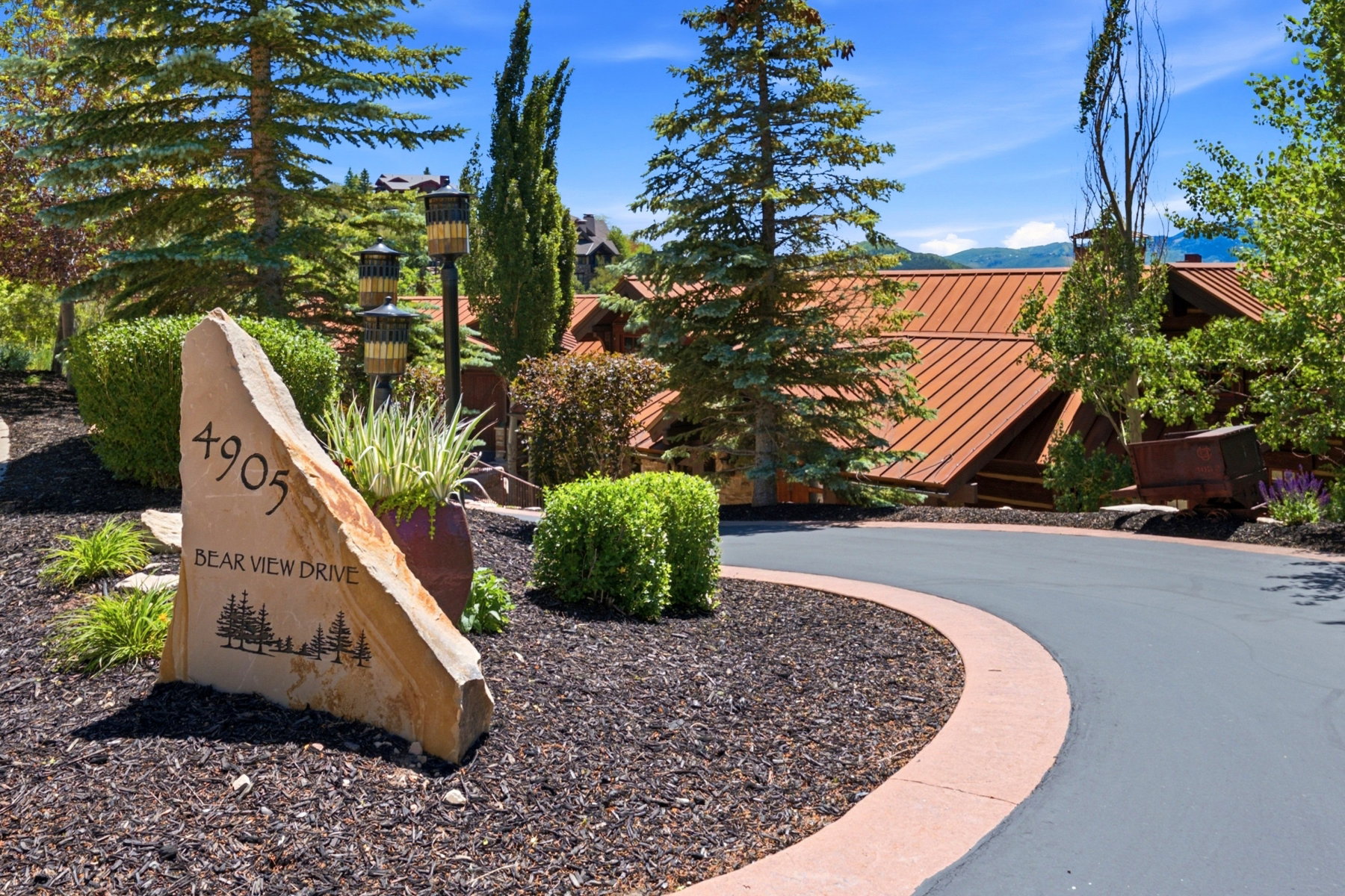 Custom stone address marker set amidst landscaping