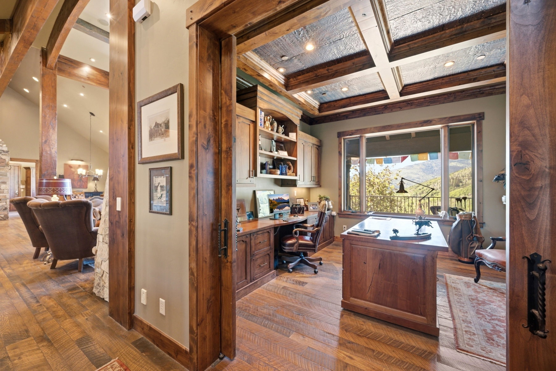 Room featuring wood-finish flooring, exposed wood beams, and a coffered ceiling with recessed lighting