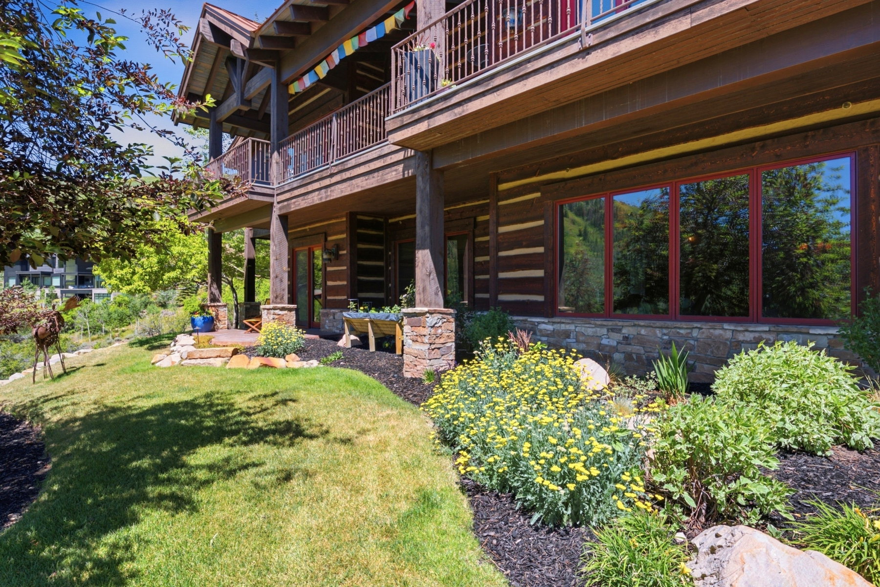 Multi-level exterior featuring natural wood siding and stone accents