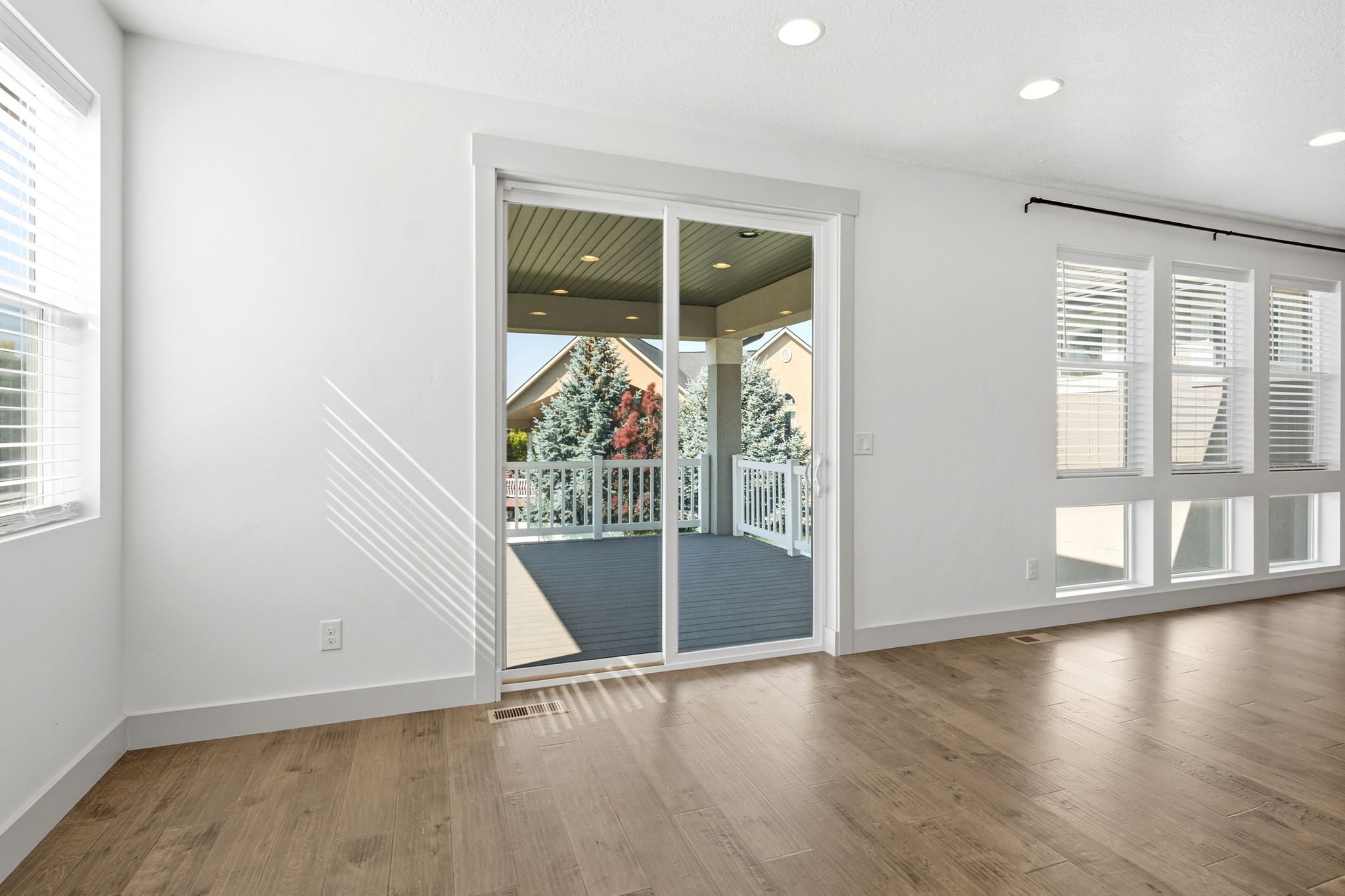 Spacious interior featuring wood-finish flooring and white baseboards