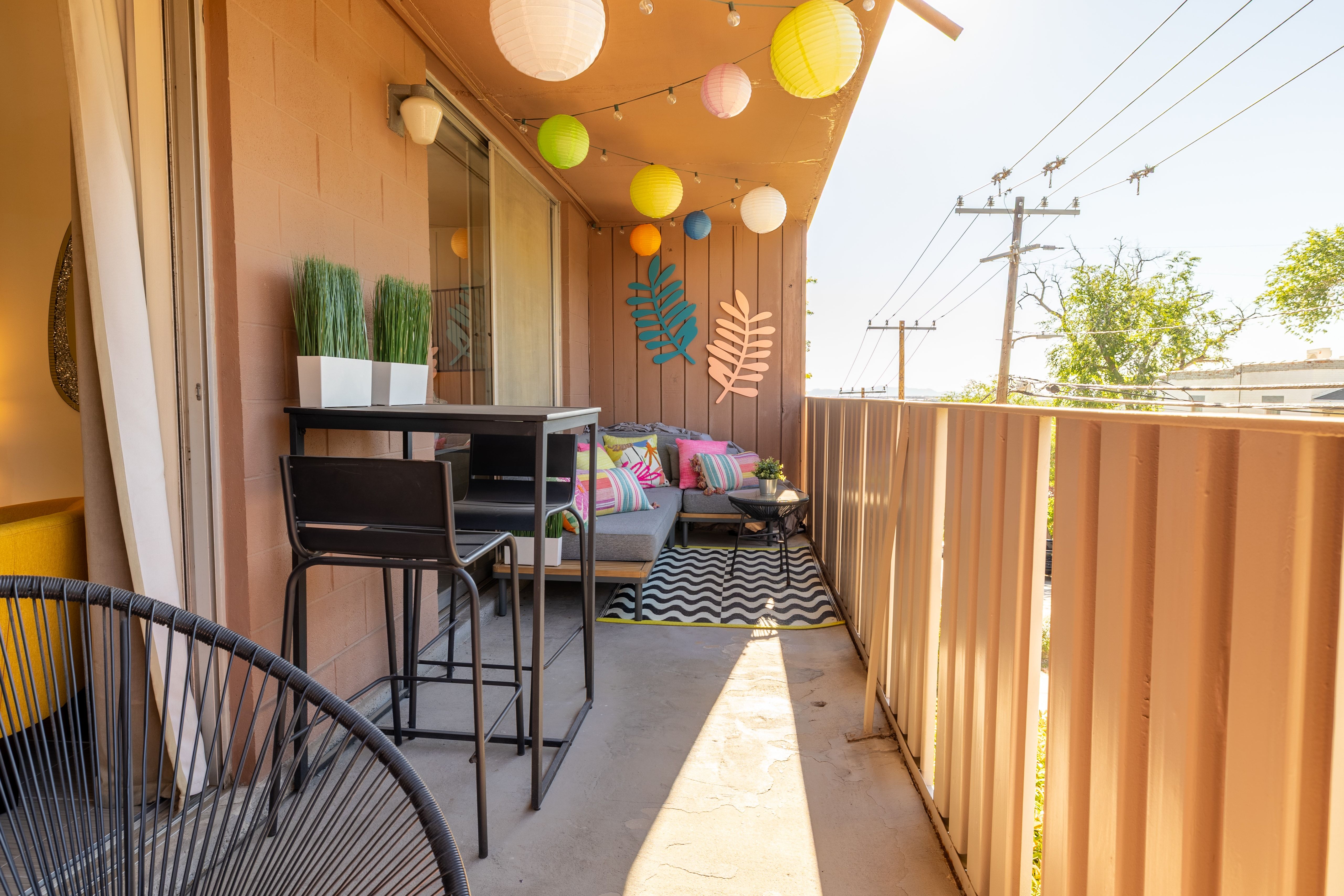 Private exterior balcony with a concrete floor and a metal railing