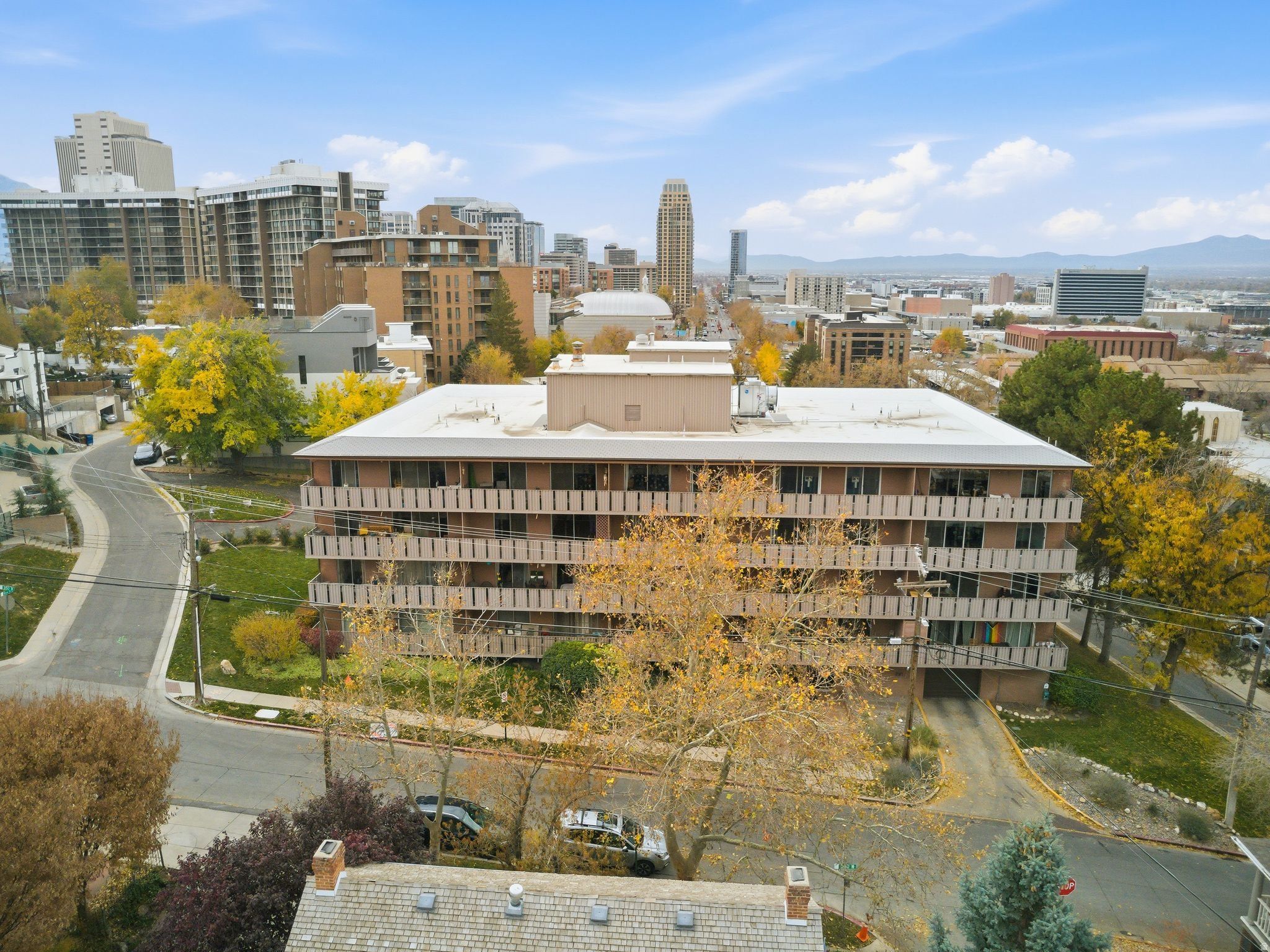 Multi-story building featuring a brick facade and private balconies