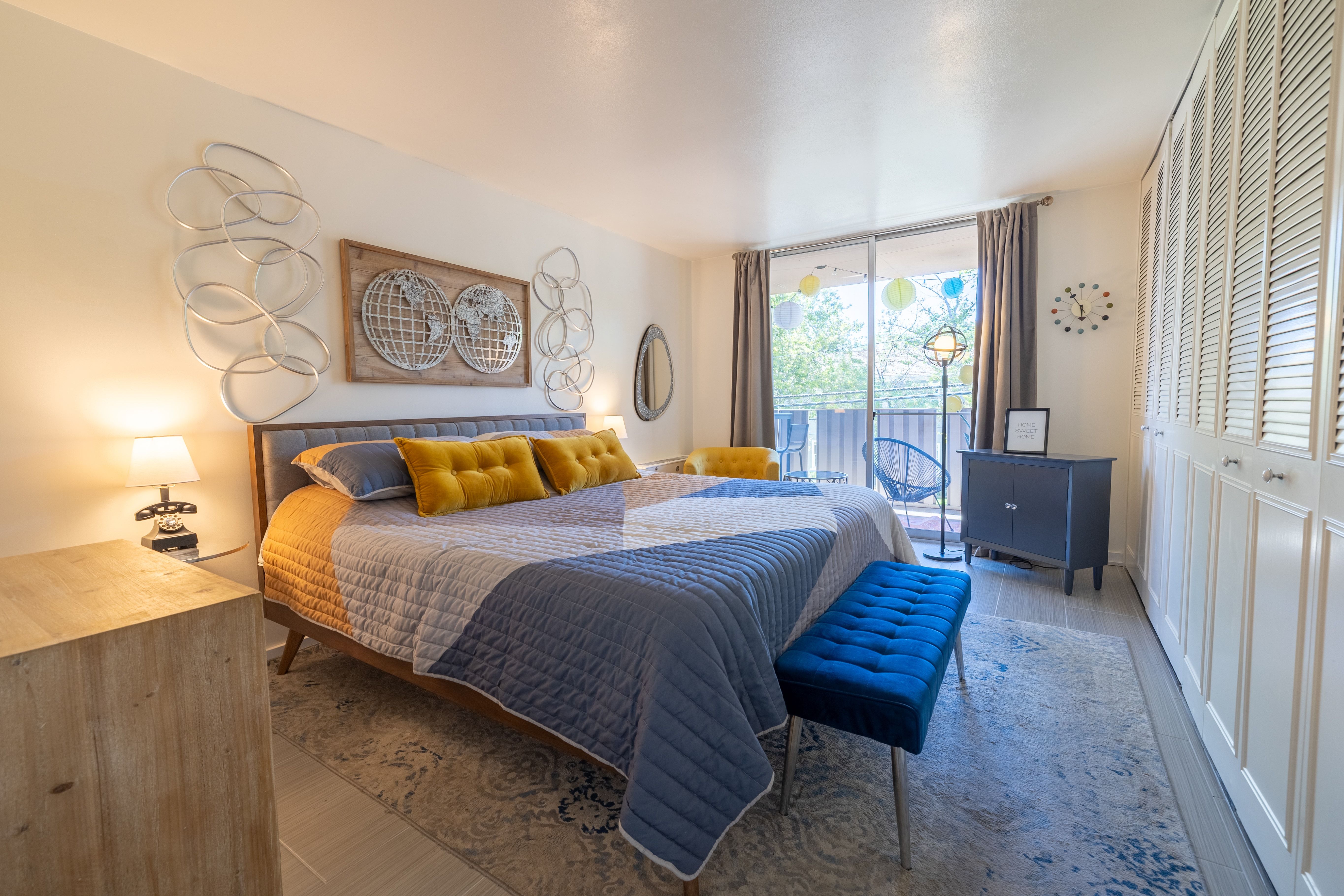 Spacious room featuring a large sliding glass door, a private outdoor area, and extensive built-in louvered cabinetry