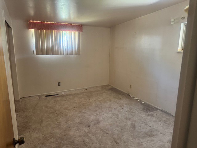 Interior space featuring two windows with vertical blinds