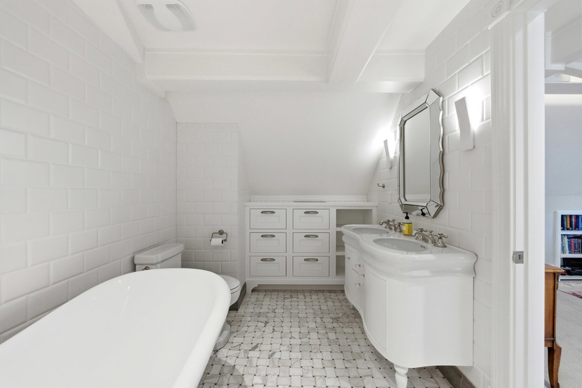 White subway tile walls with a classic freestanding tub