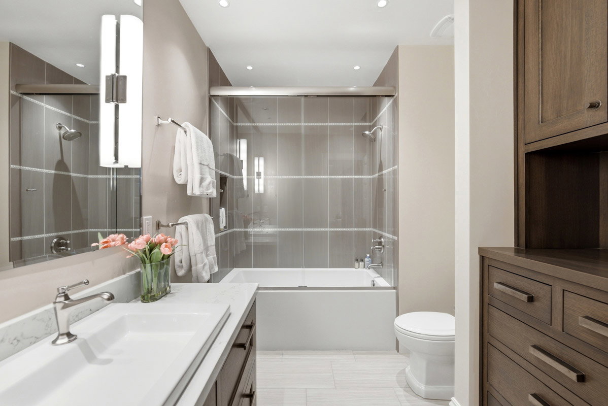 Contemporary bathroom featuring a combined shower and soaking tub with full-height tile surround