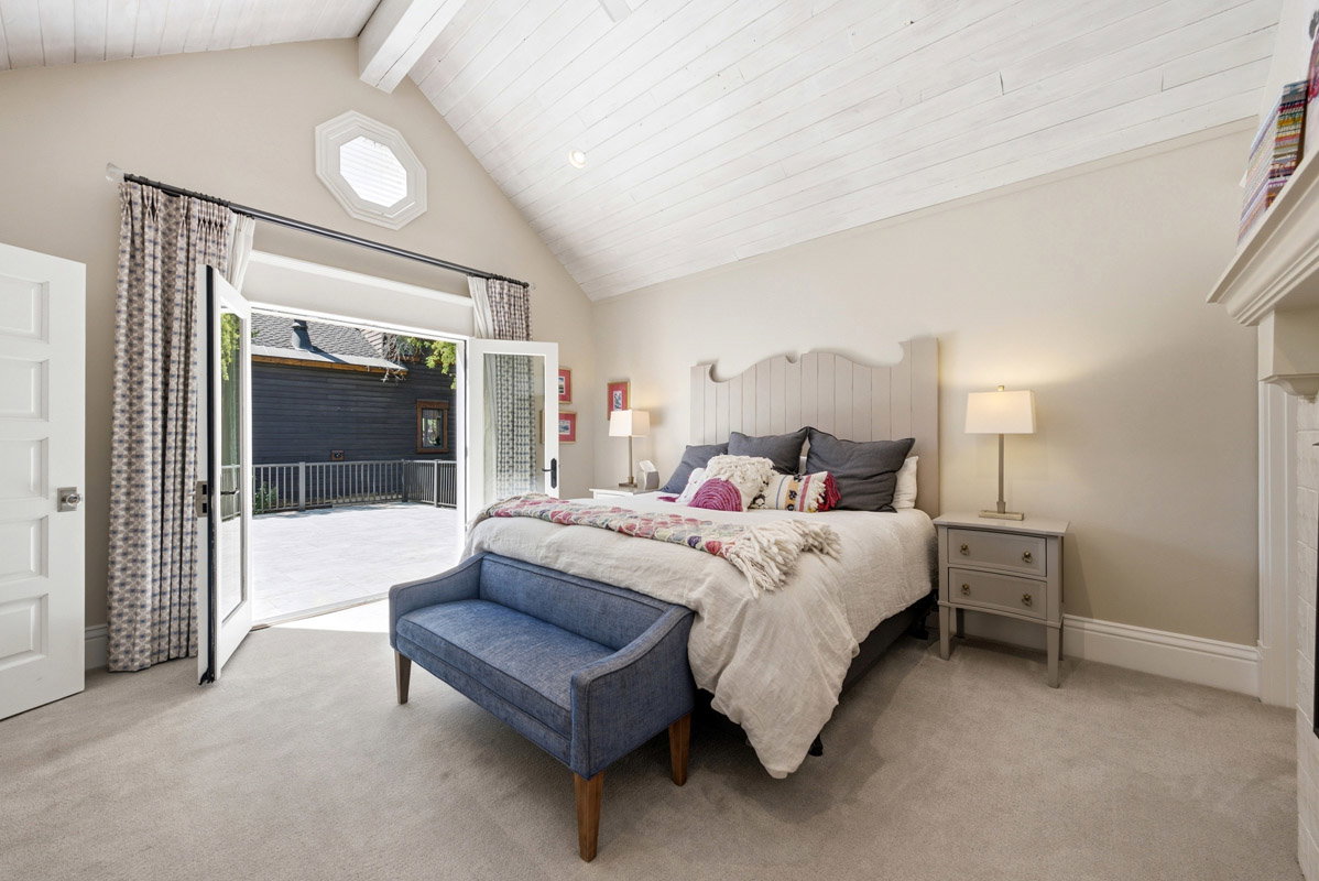 Vaulted white wood-paneled ceiling with exposed beams