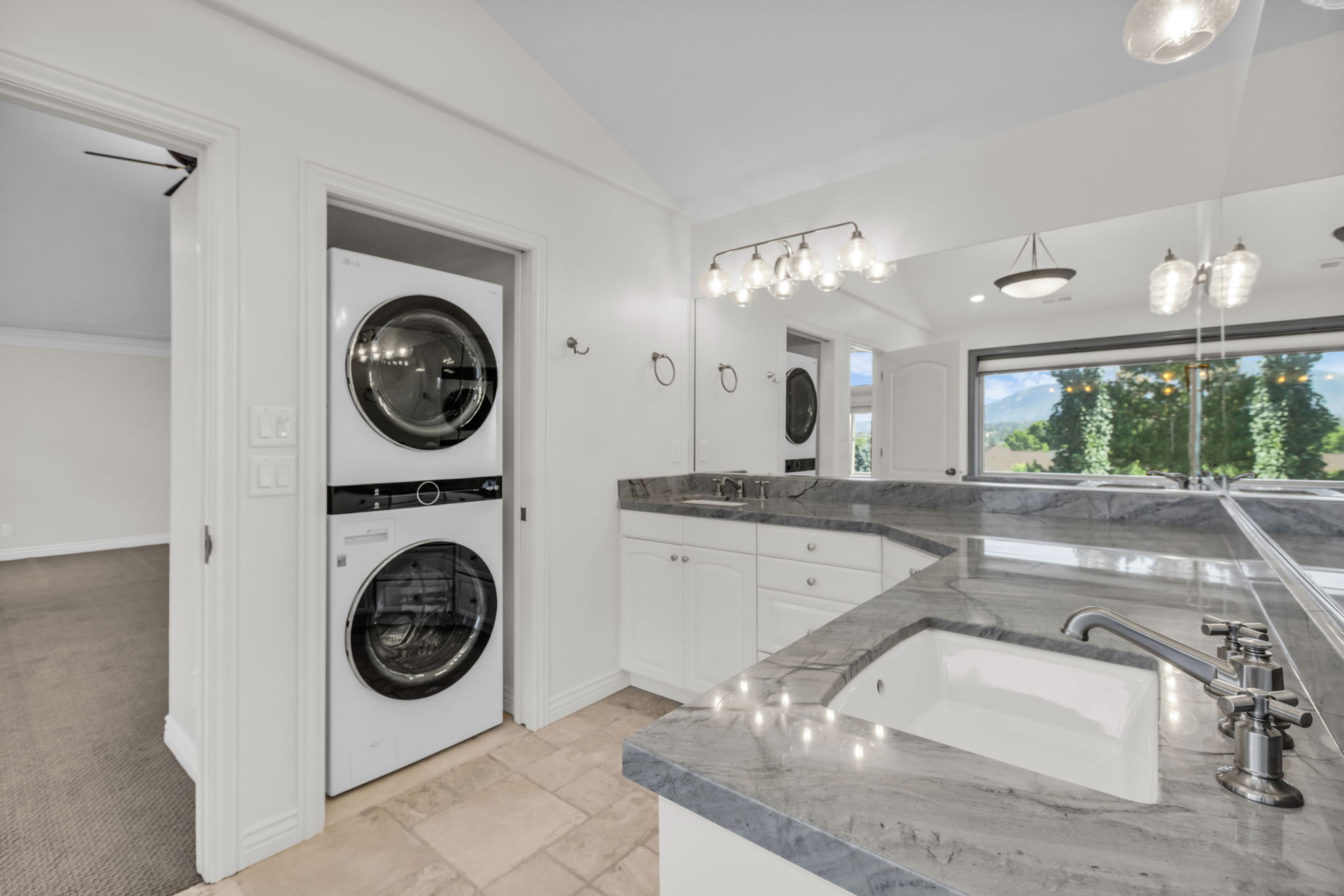 Bathroom vanity with a double undermount sink and stone countertops