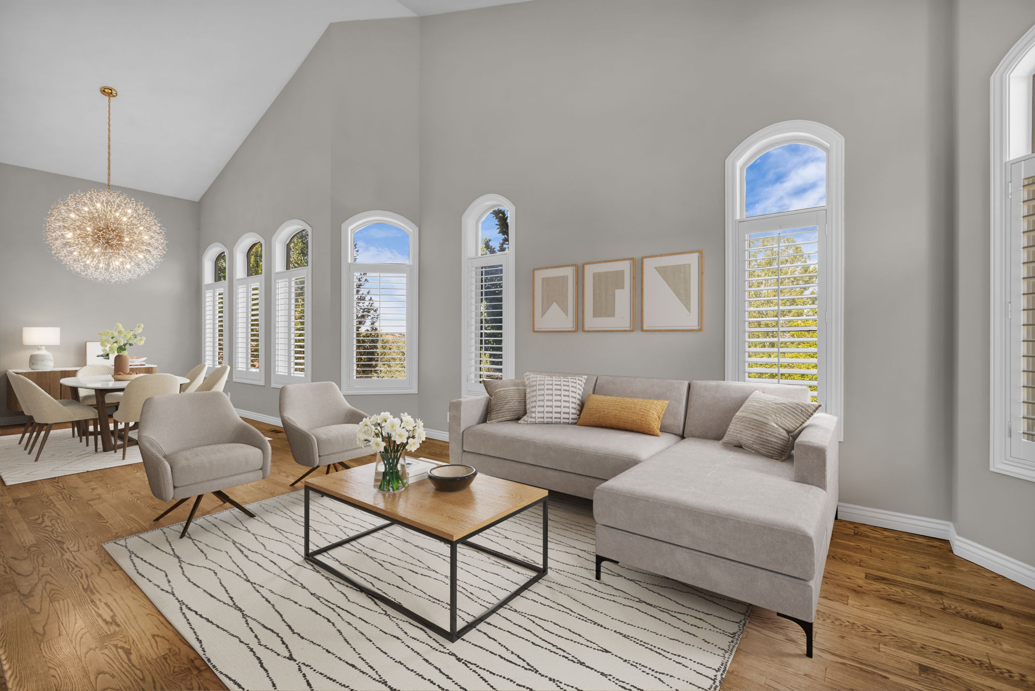 Expansive living area with vaulted ceilings and wood-finish flooring