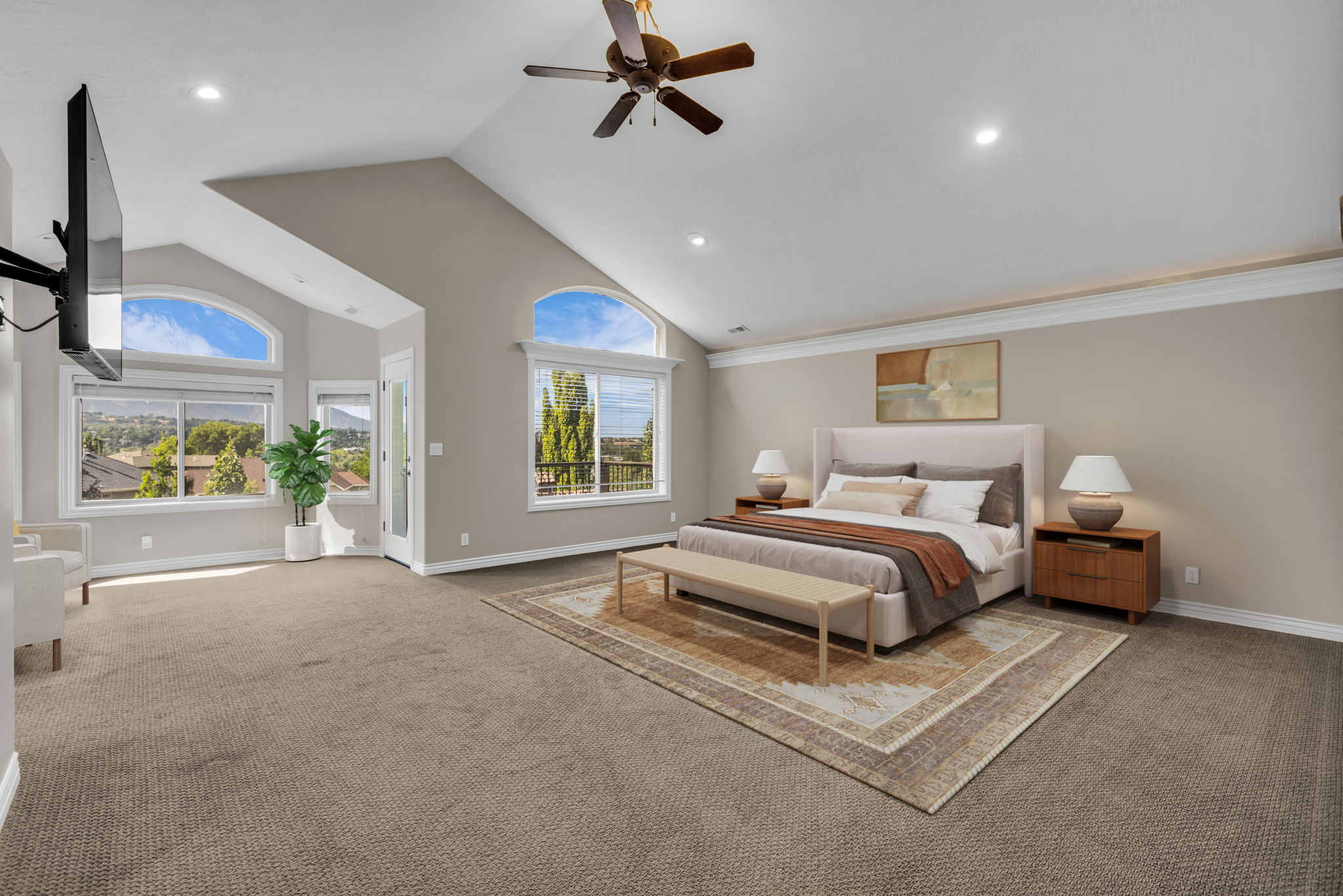 Vaulted ceilings featuring a ceiling fan, recessed lighting, and expansive windows