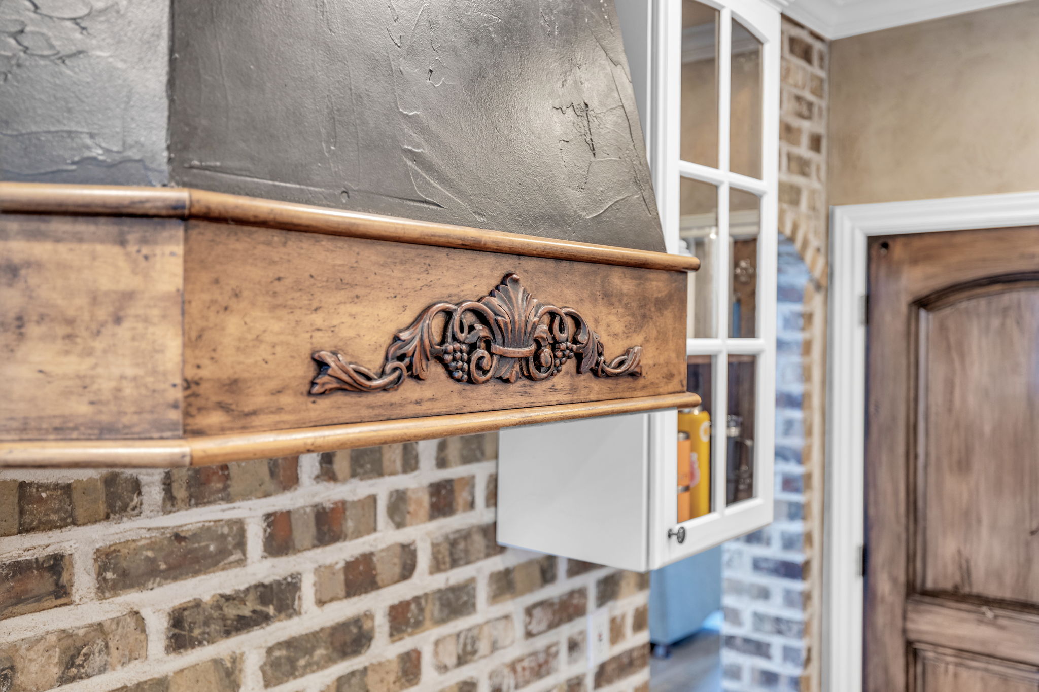 Custom range hood with decorative wood-finish trim