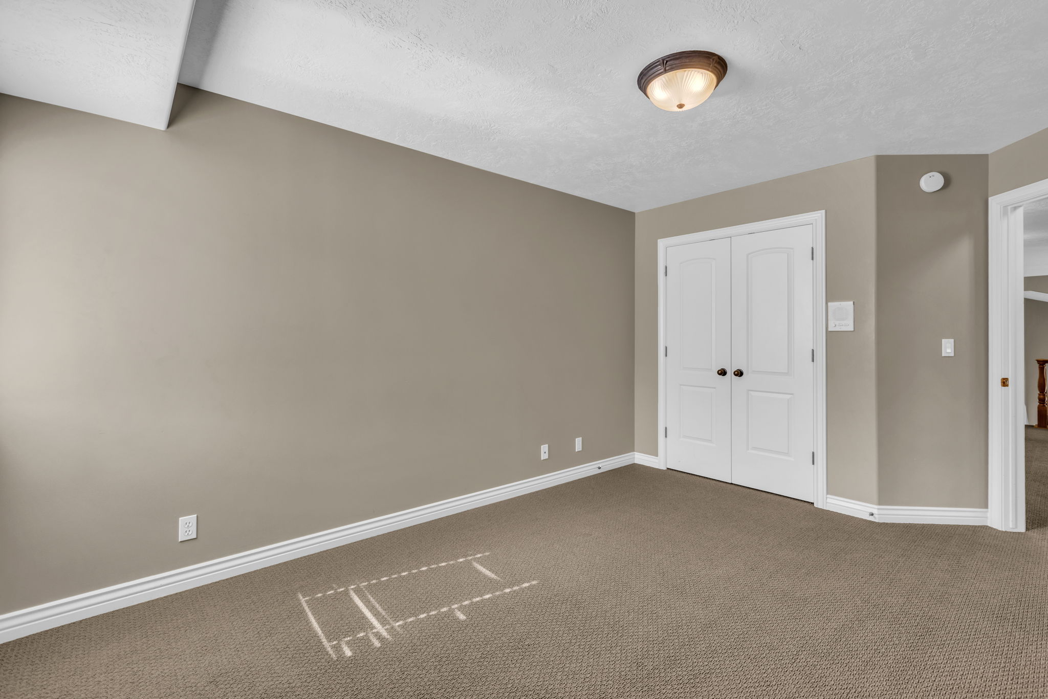 Neutral tone walls with white baseboards and trim