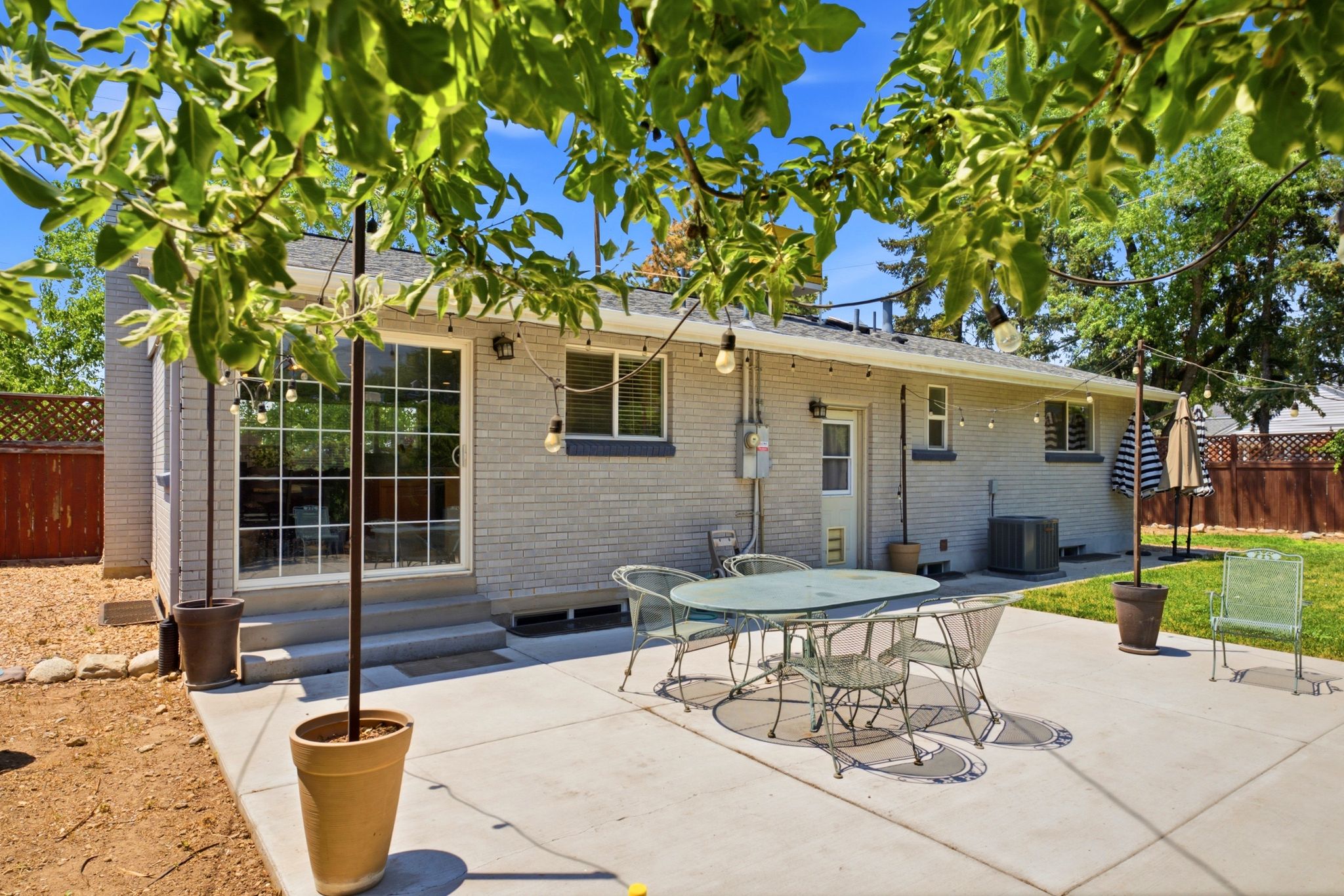 Concrete patio with brick exterior and sliding glass door