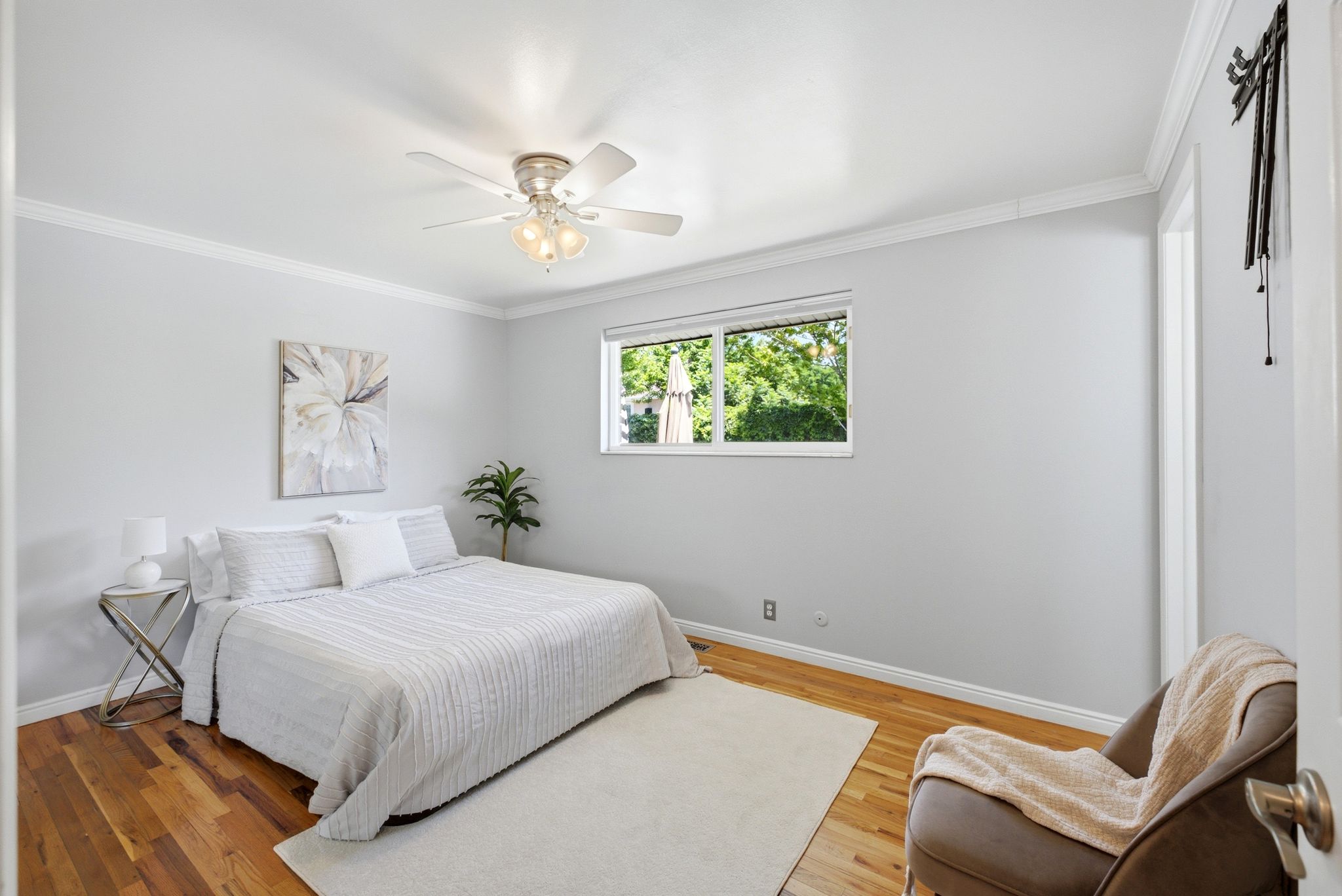 Master Bedroom featuring wood-finish flooring, white walls, and a window with exterior views