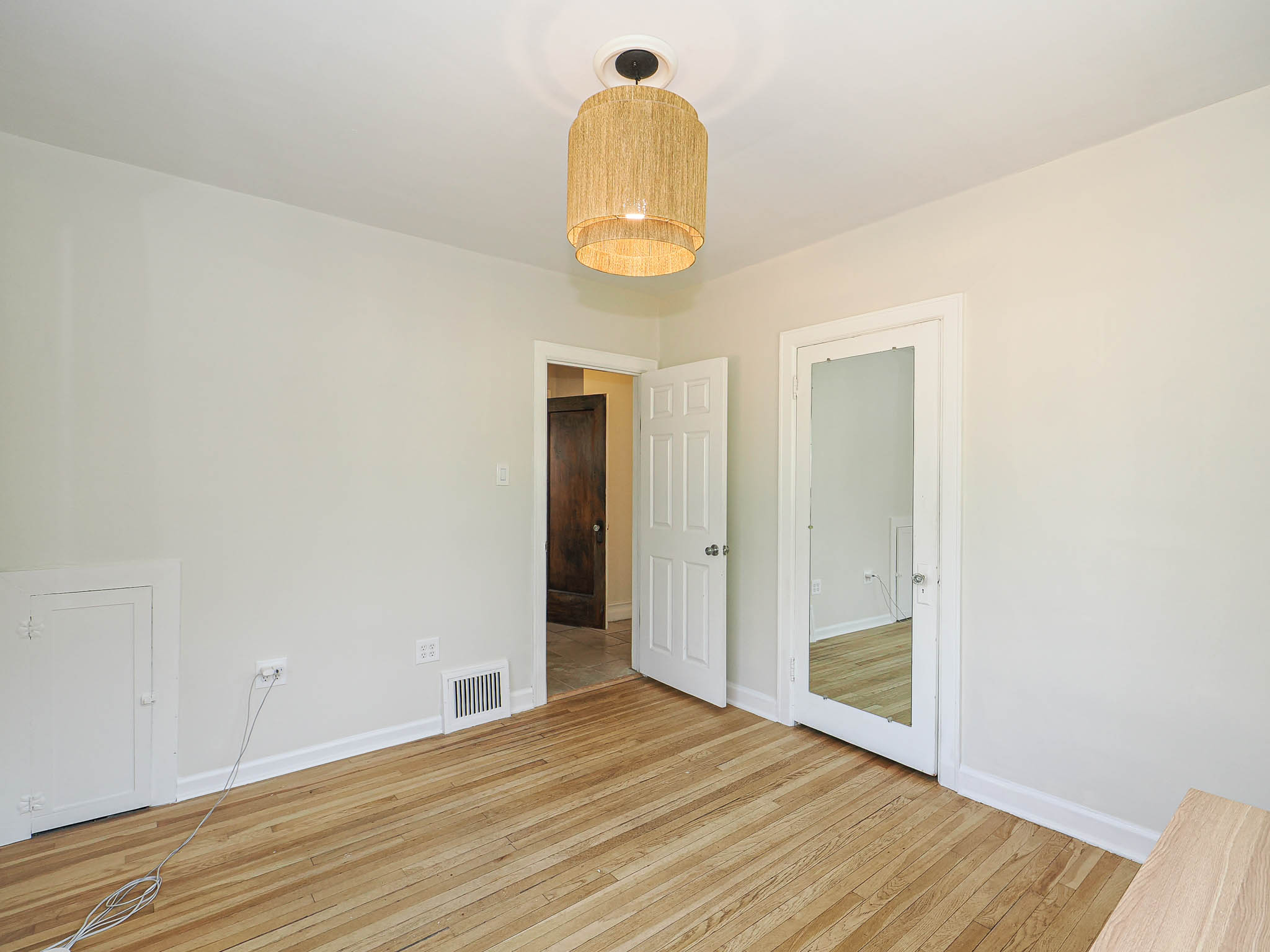 Hardwood flooring accents this interior space featuring light-toned walls