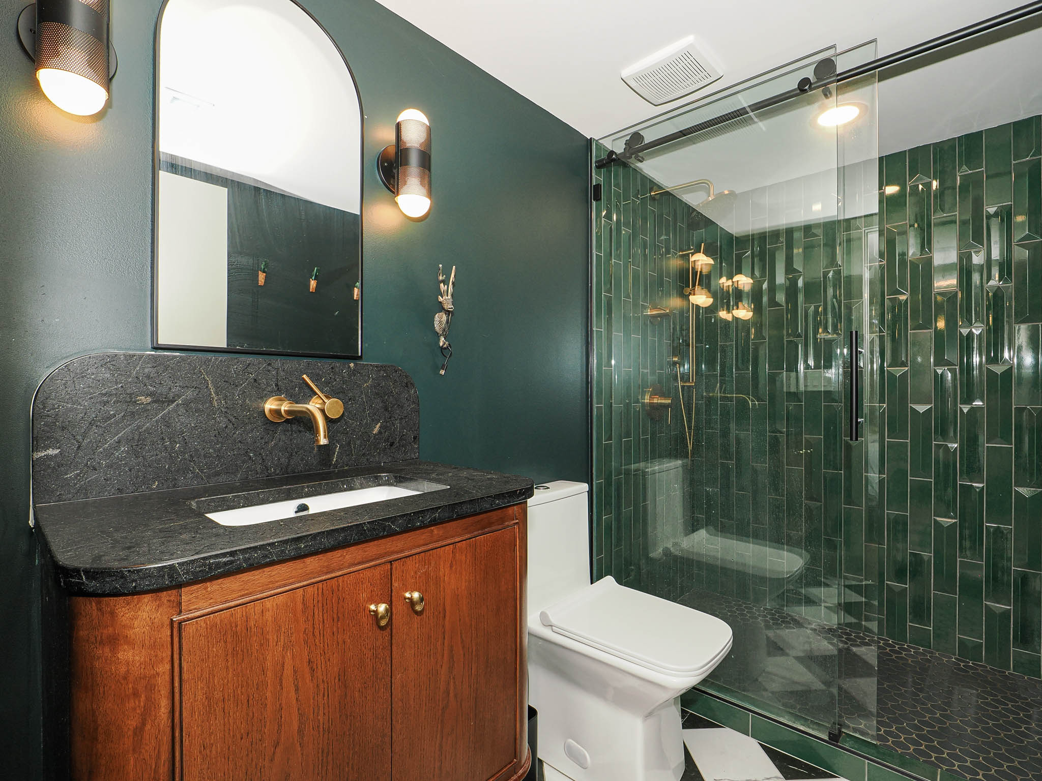 Bathroom featuring a dark wood vanity with a stone countertop and integrated sink