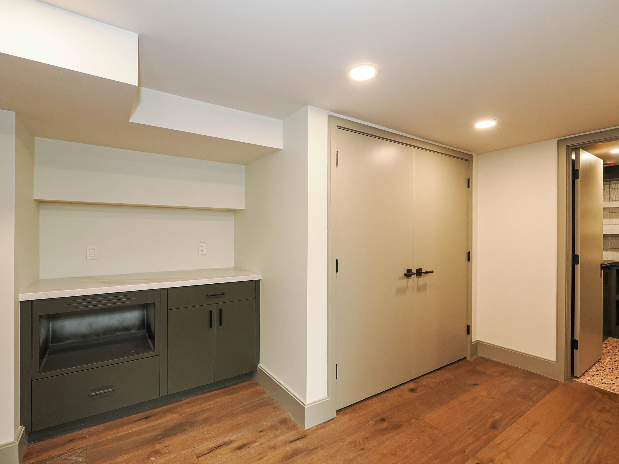 Built-in cabinetry with a light-toned countertop and open shelving