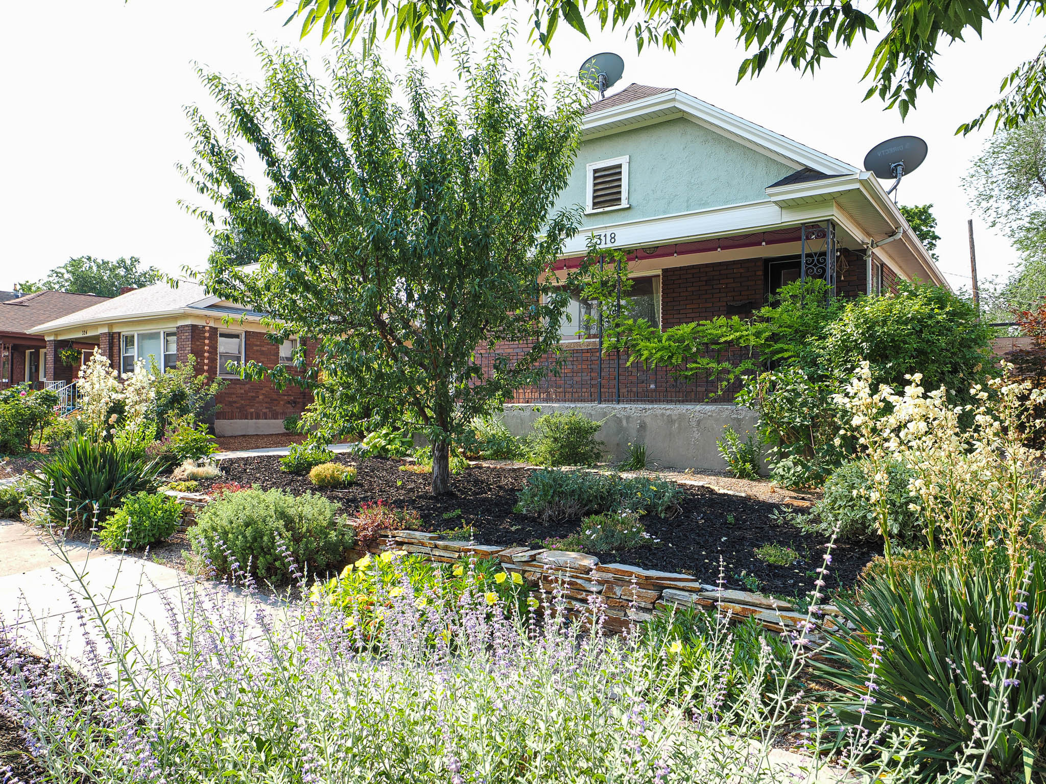 Front exterior featuring brick and stucco siding with an inviting covered porch