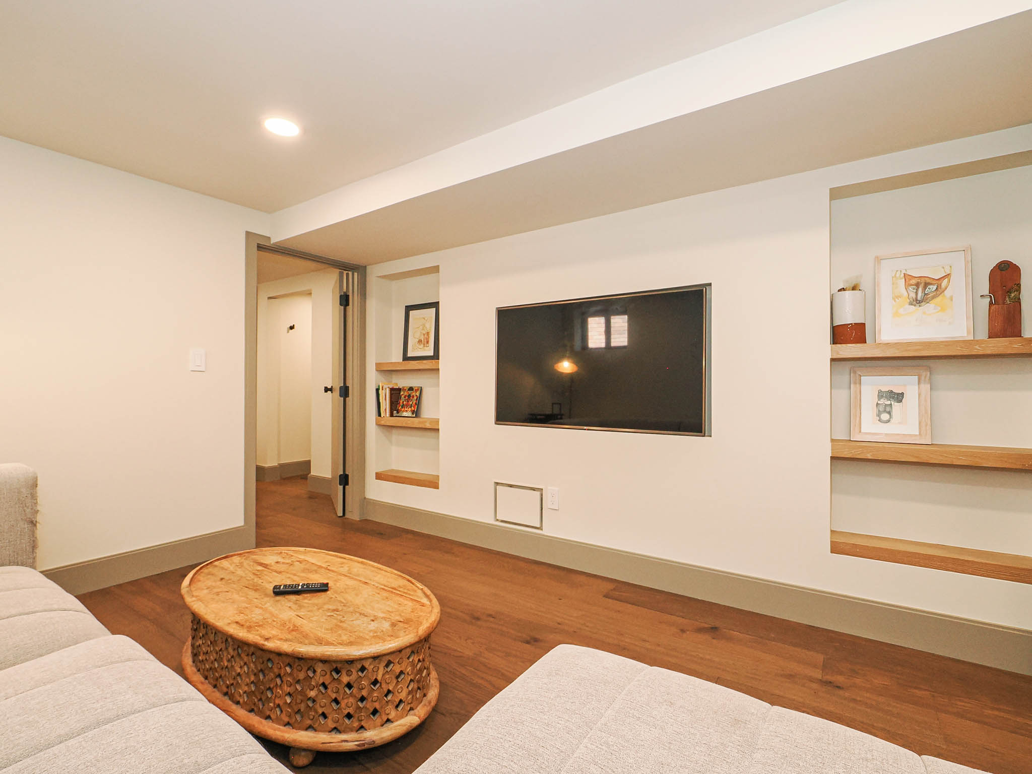 Recessed lighting illuminating wood-finish flooring