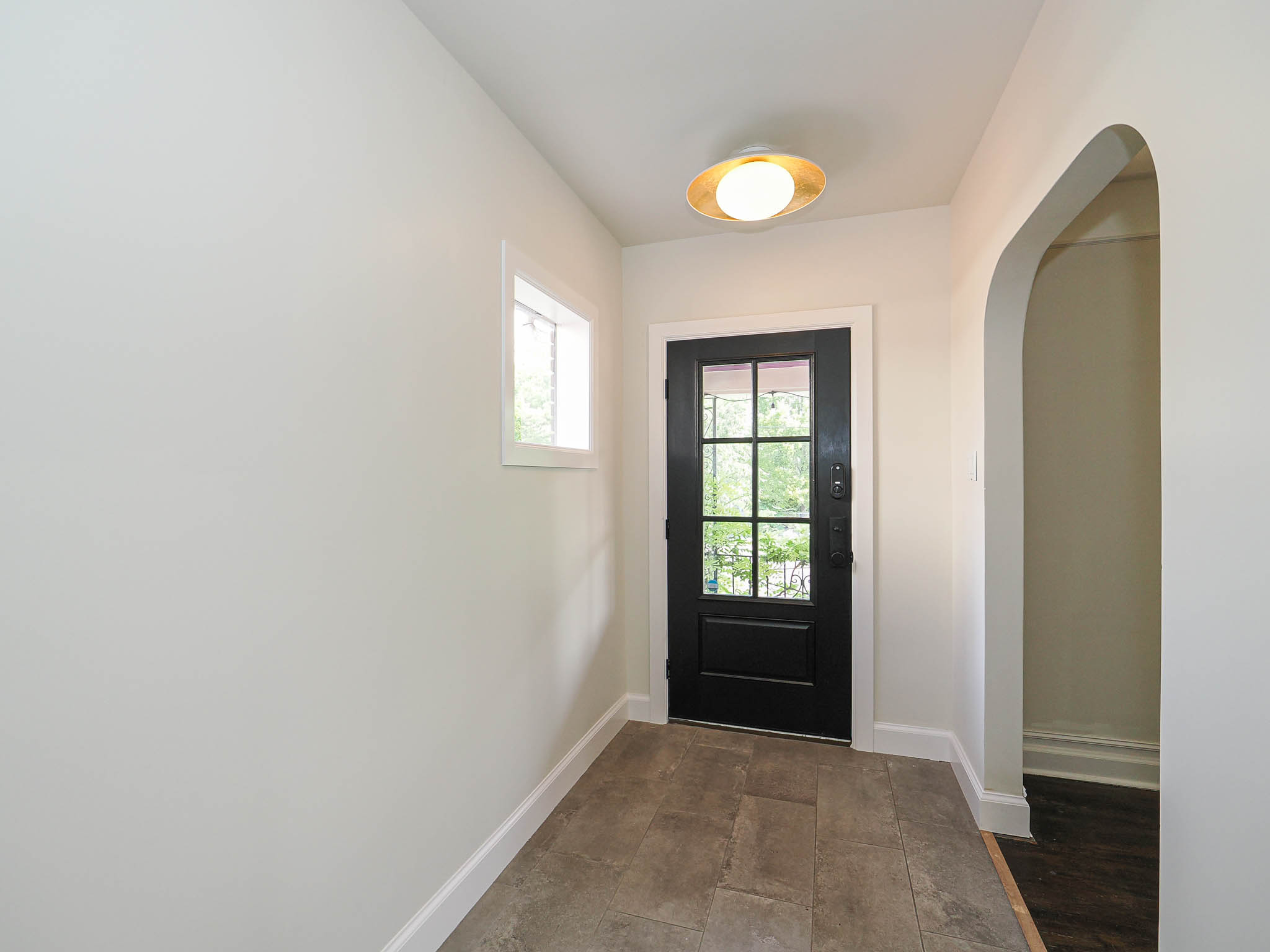 Entryway featuring a black multi-pane door, tile flooring, and a flush mount ceiling light