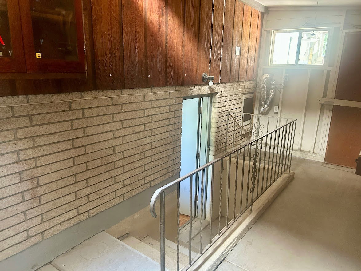 Stairs from lower level leading into the garage