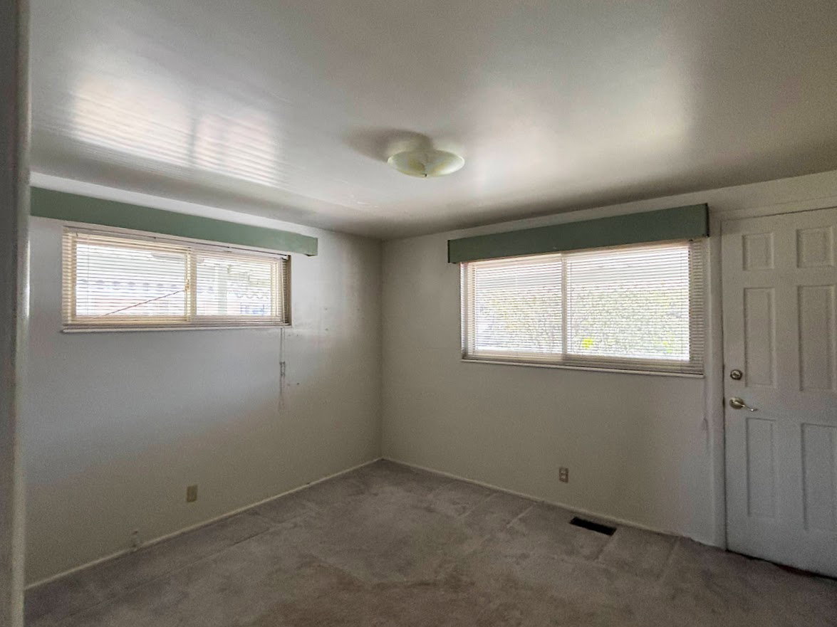 Bedroom #3 or could be used as a study/den. Door leads out to the patio