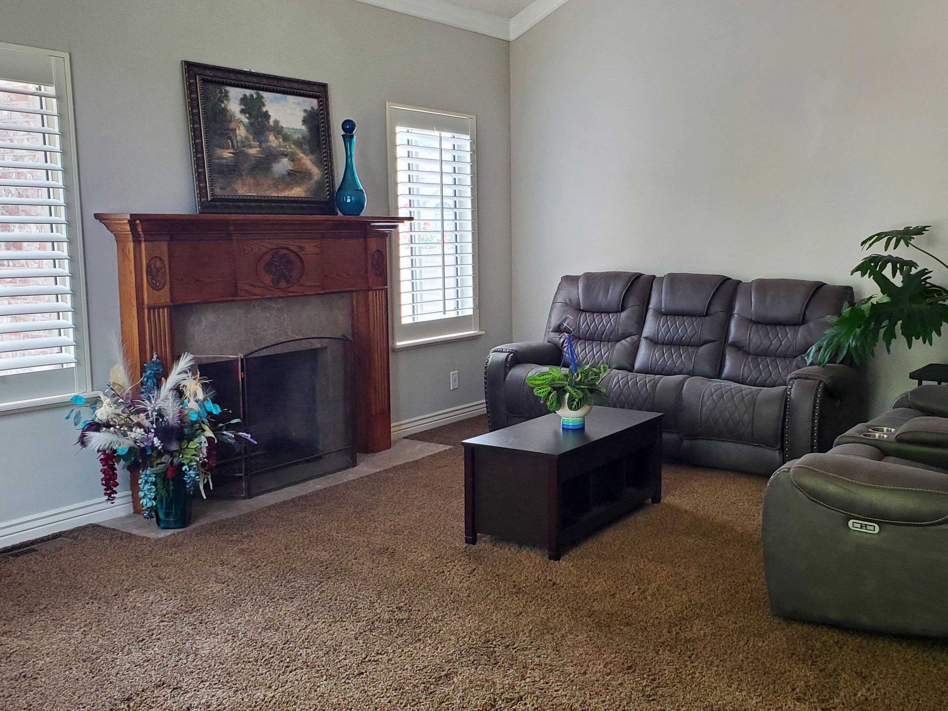 Fireplace featuring an ornate wood-finish mantelpiece, hearth, and metal fire screen