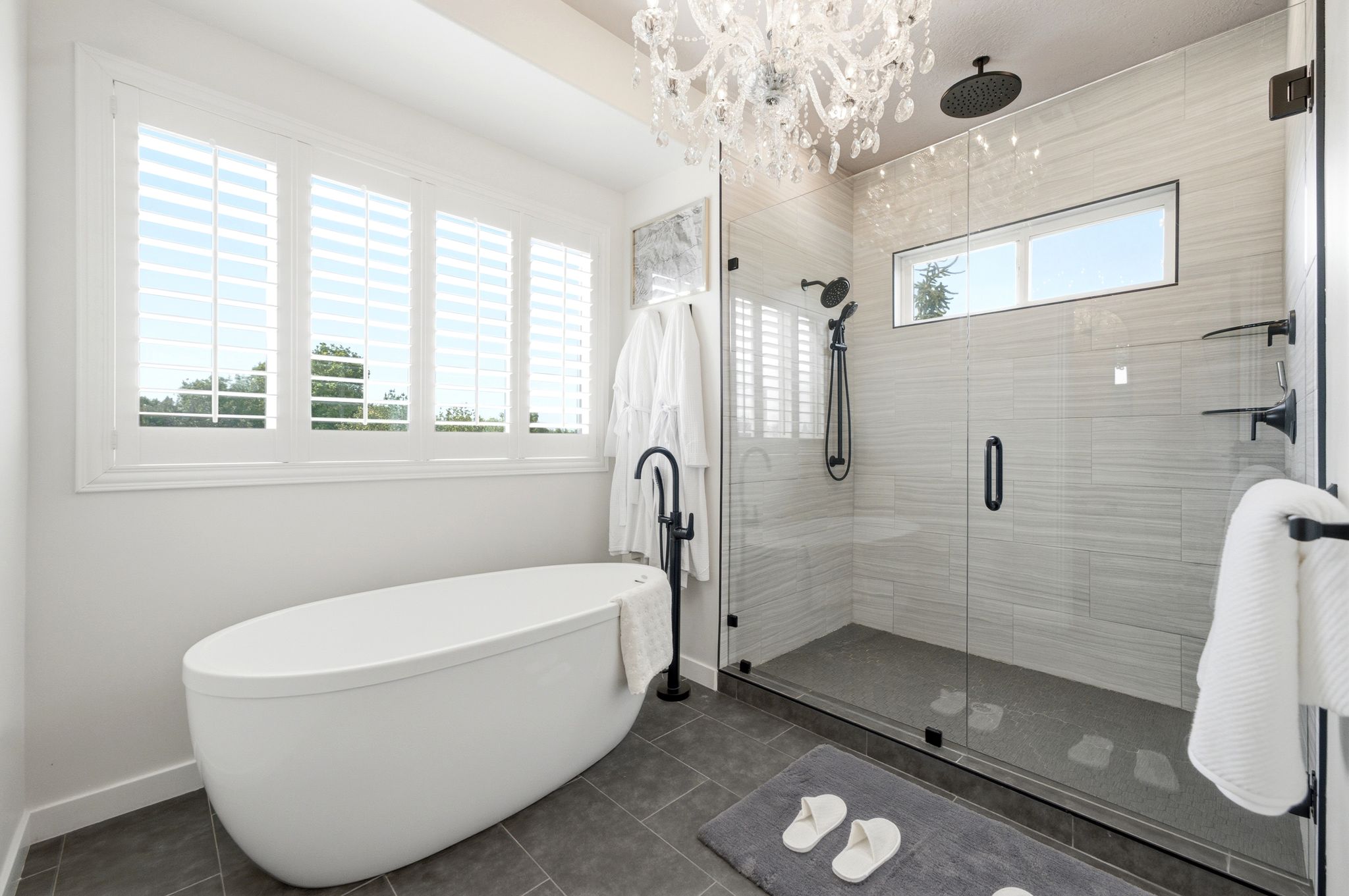 Freestanding soaking tub with a floor-mounted matte black faucet