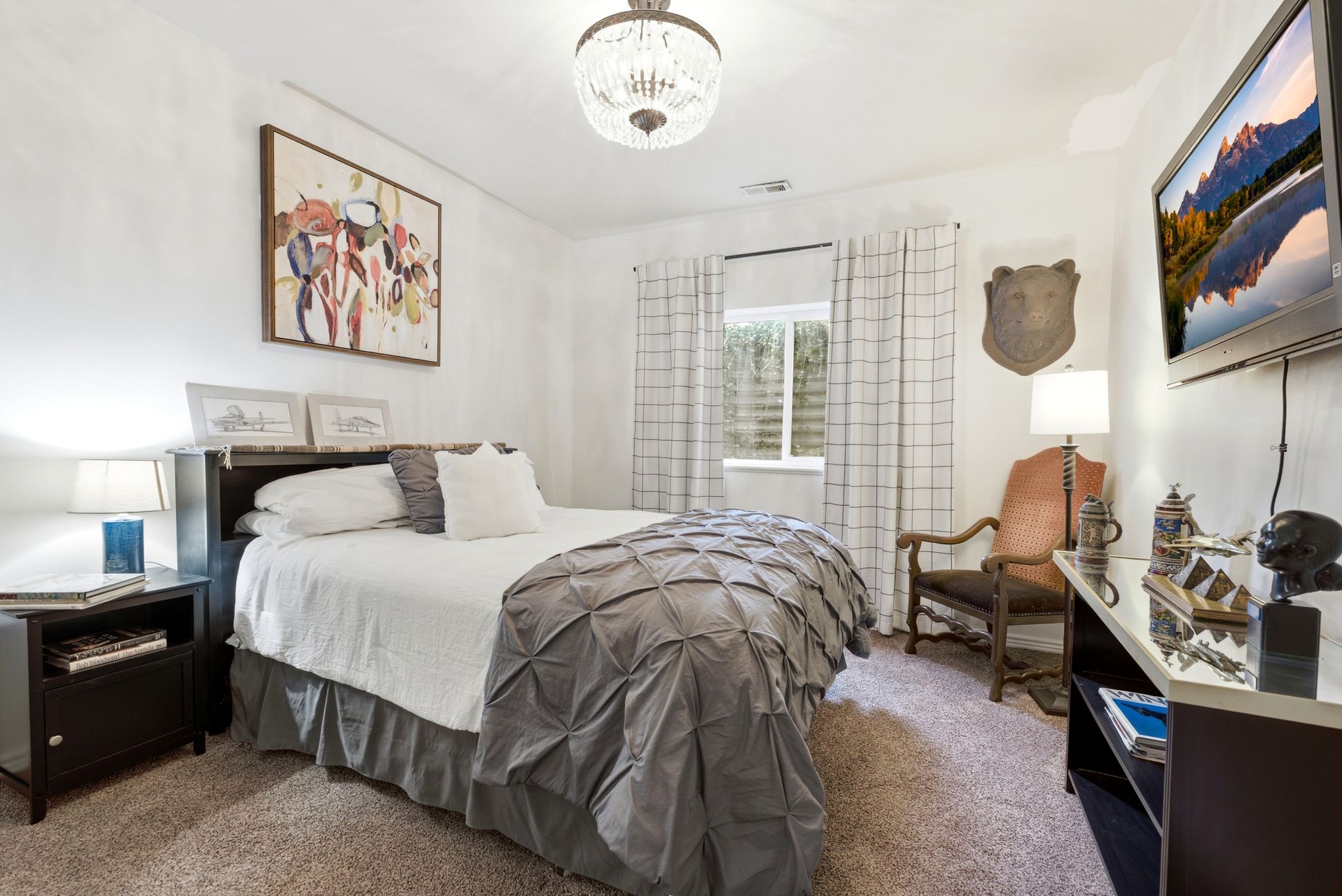 Recessed window with white blinds and patterned drapes